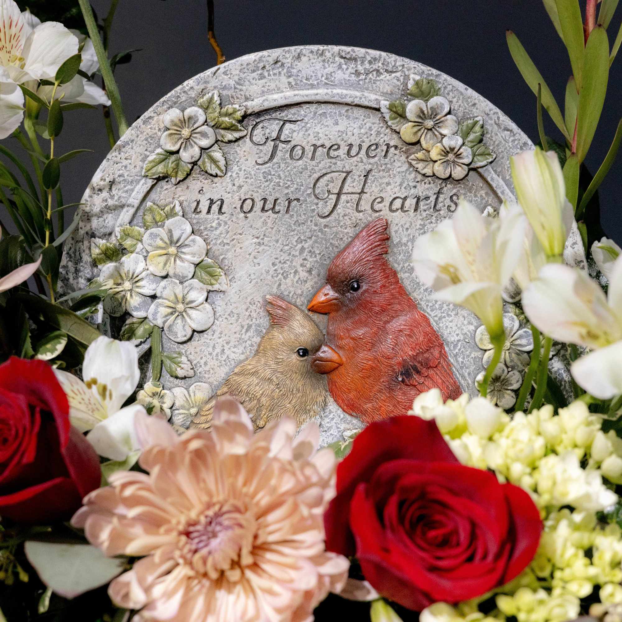 A sweet arrangement with a keepsake stepping stone of a Cardinal and