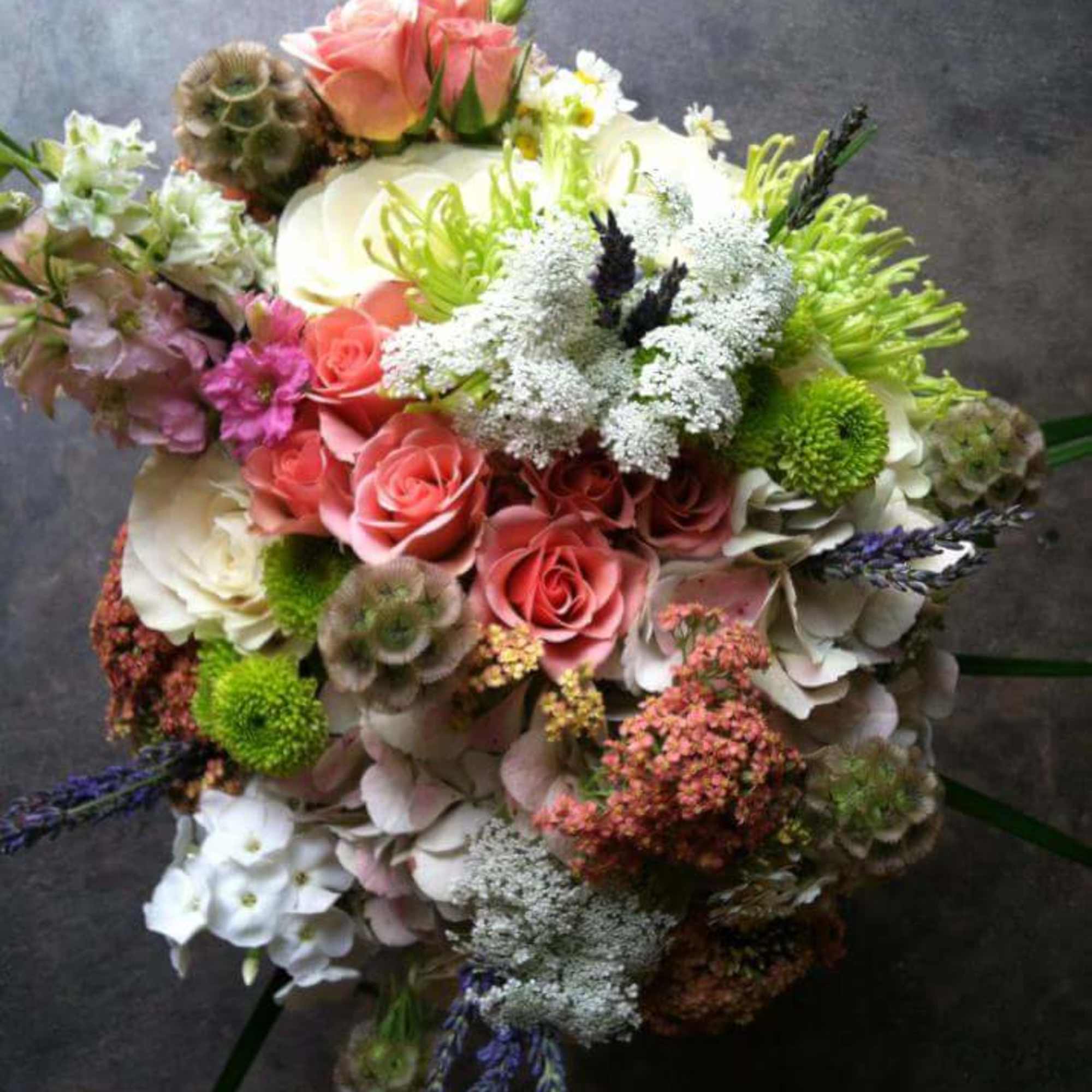 Mixed bouquet of pink and white flowers with green accents