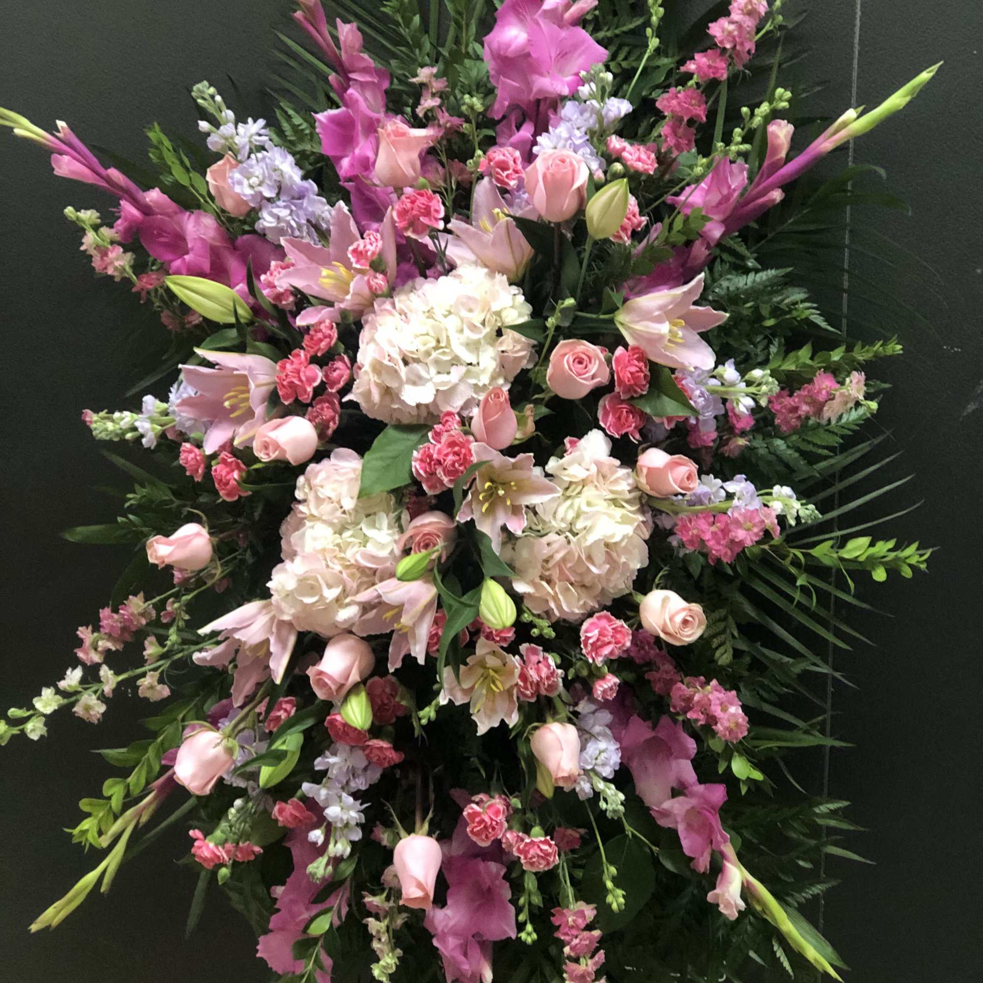 Large pink and white floral spray with lilies, roses, and hydrangeas