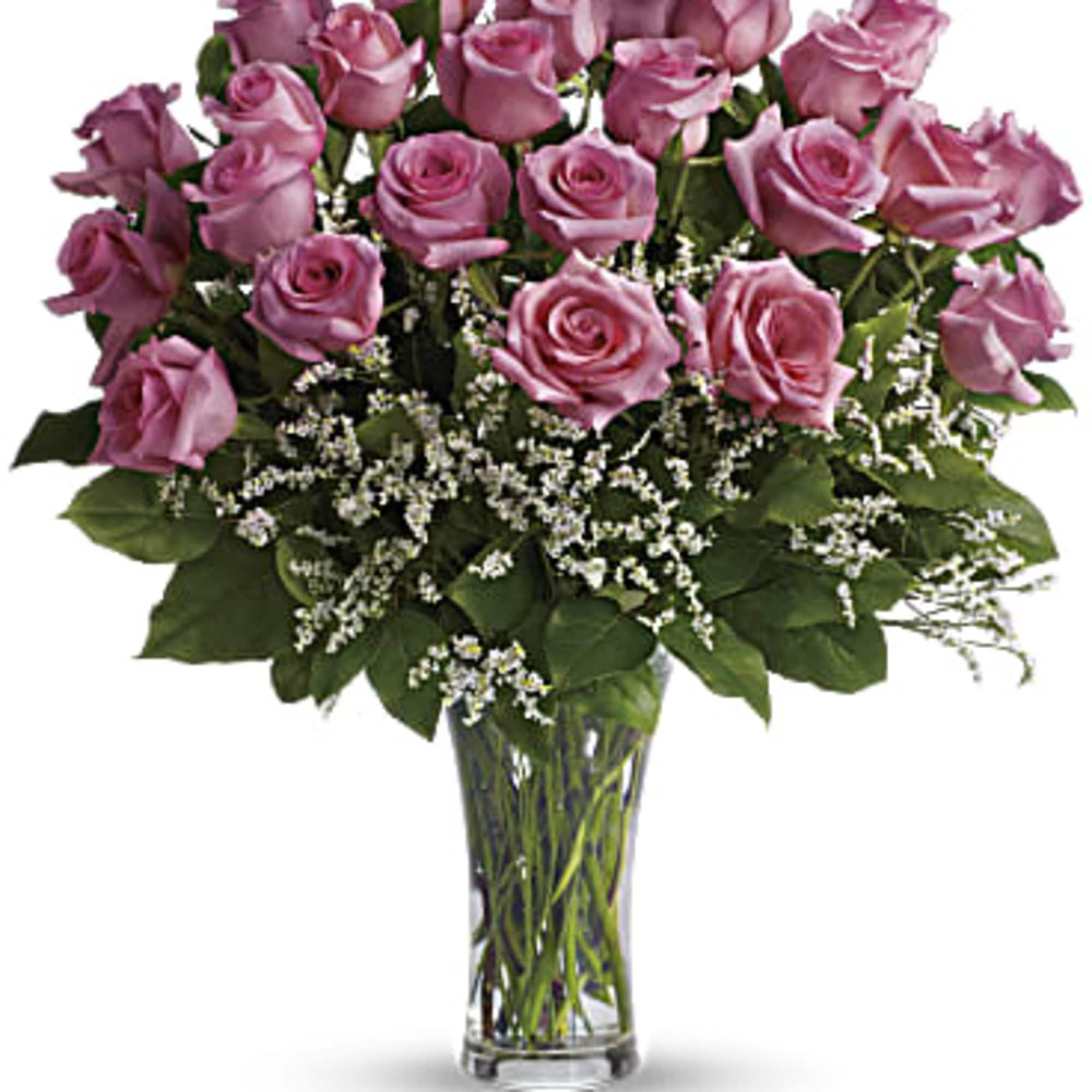Pink roses arranged in a clear glass vase with white filler flowers, photo 4 of 4