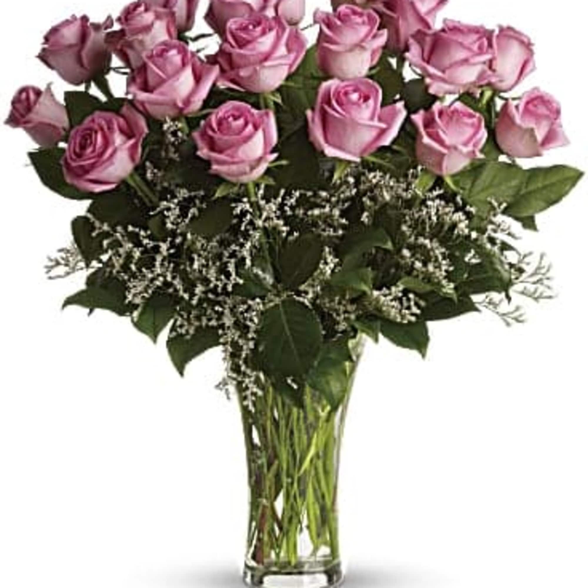 Pink roses arranged in a clear glass vase