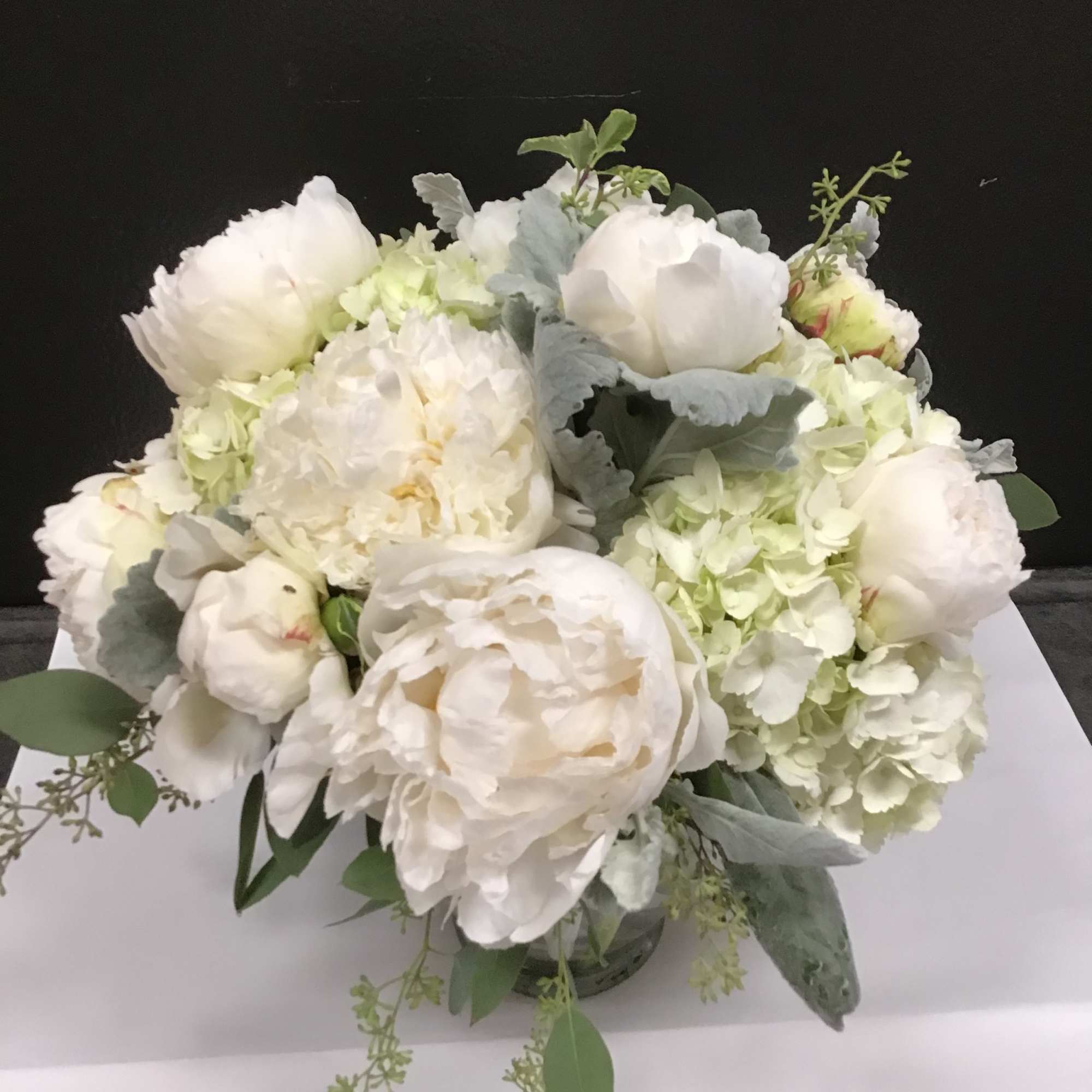 White peony and hydrangea bouquet with eucalyptus in a vase
