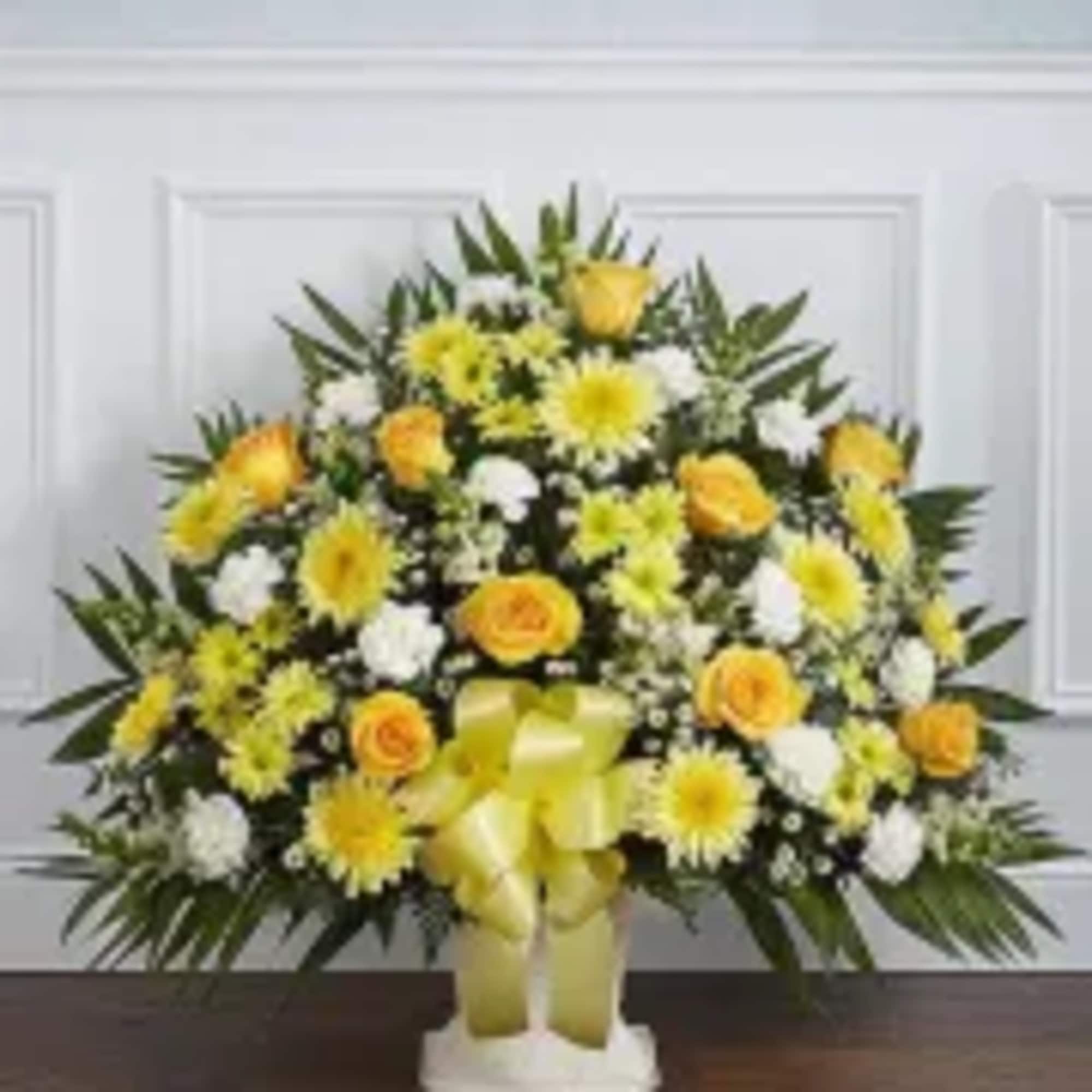 Yellow and white floral spray with a ribbon bow