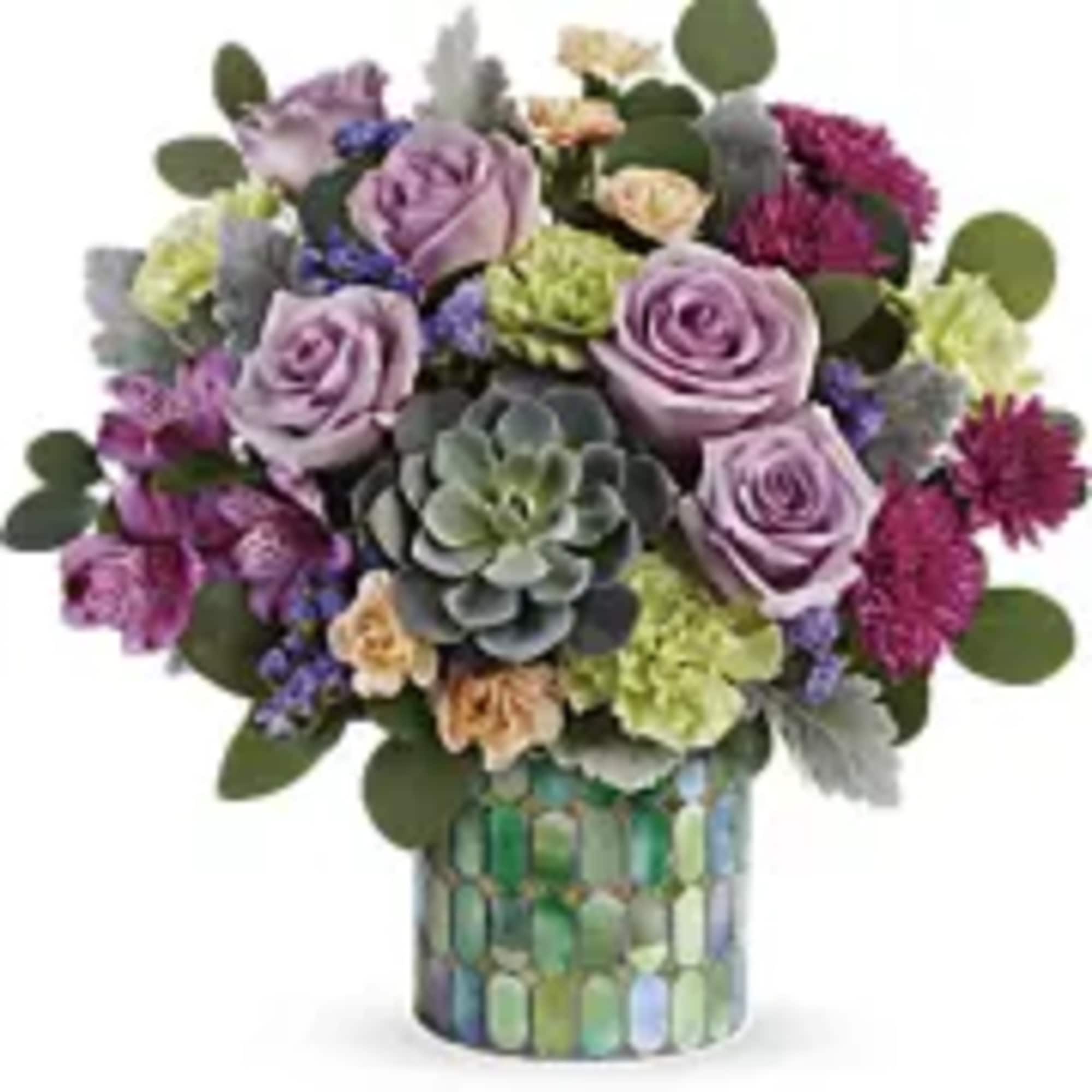 Lavender roses and mixed blooms in a mosaic glass vase