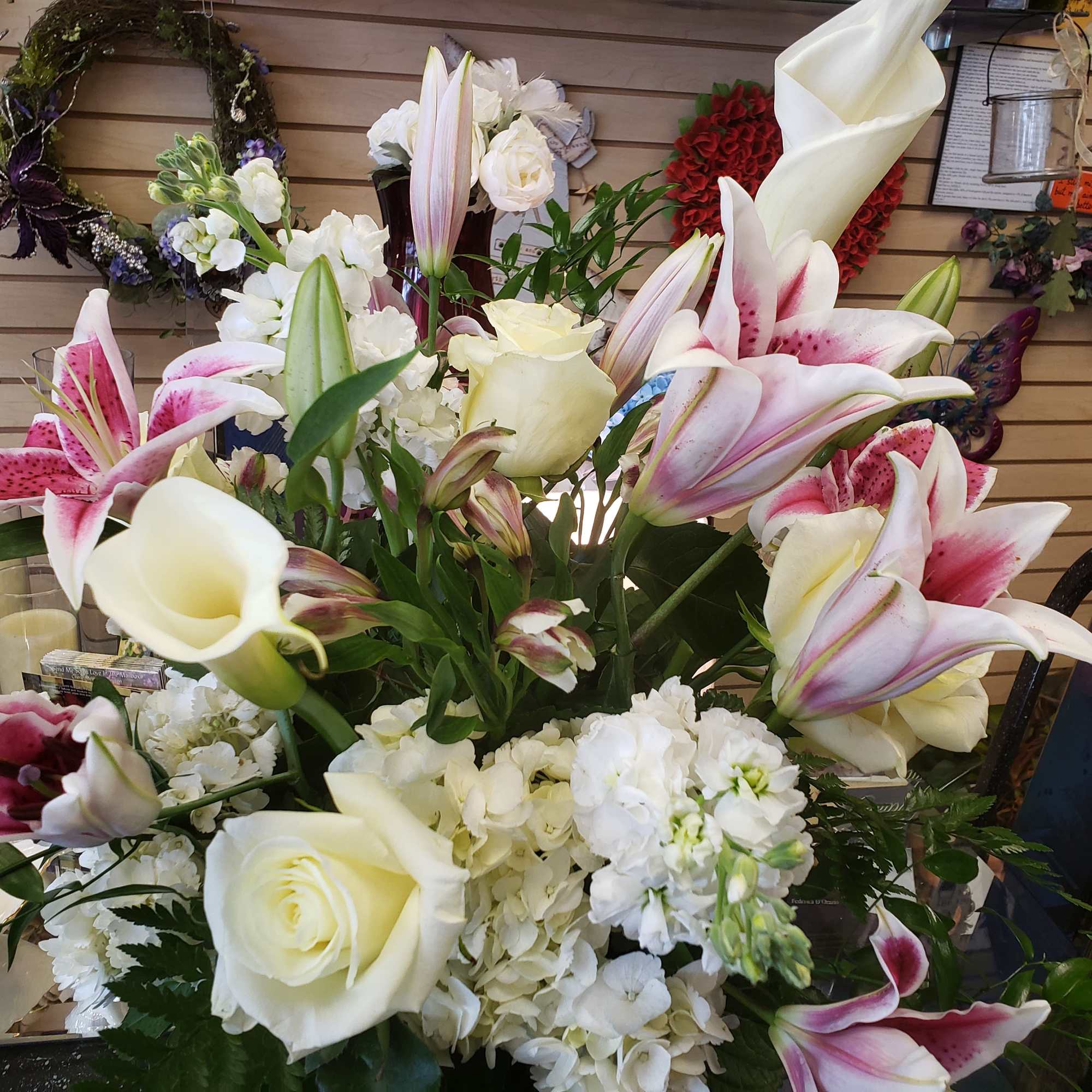 Bouquet of white roses, lilies, and hydrangeas with pink stargazer lilies