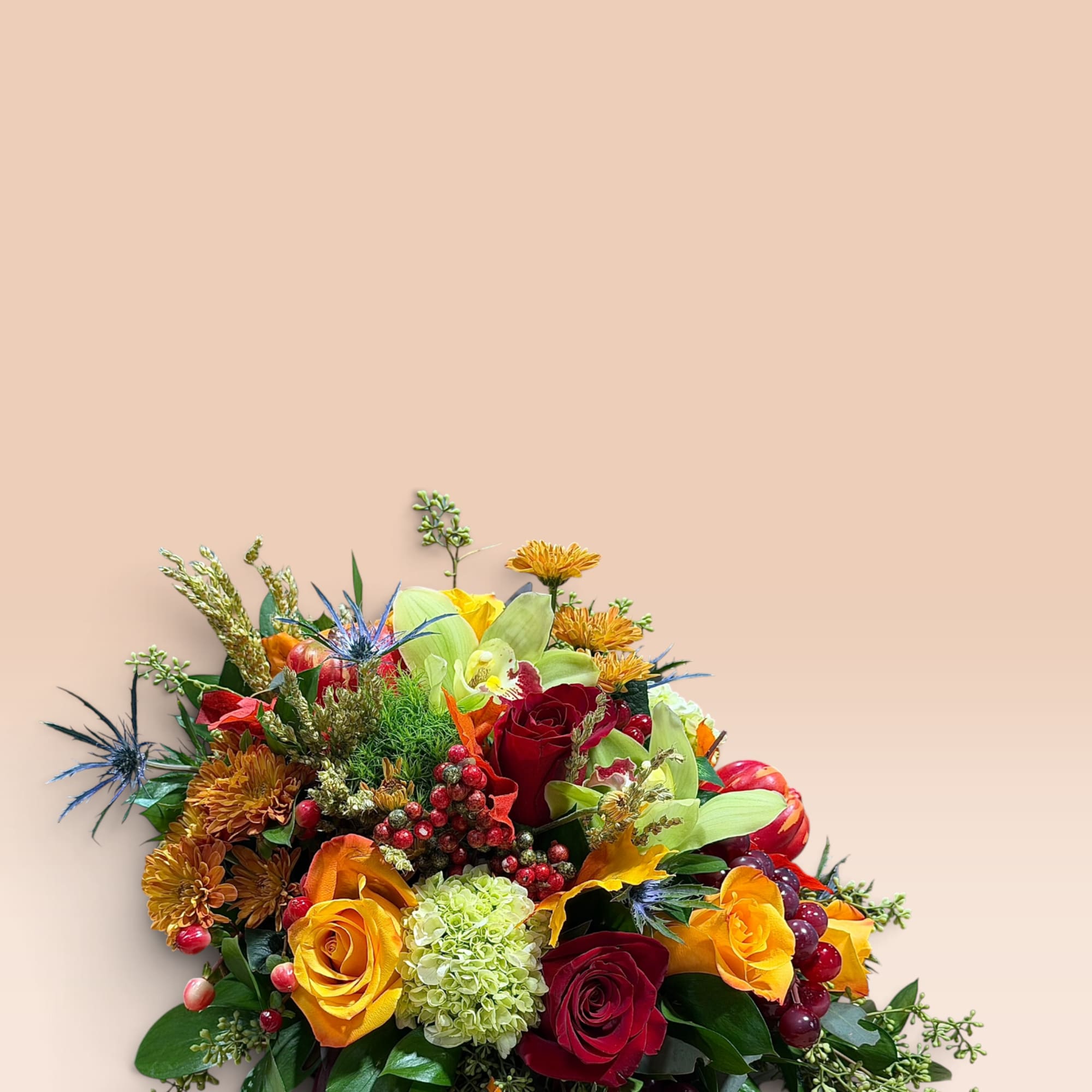 Colorful bouquet with roses, orchids, chrysanthemums, and grapes