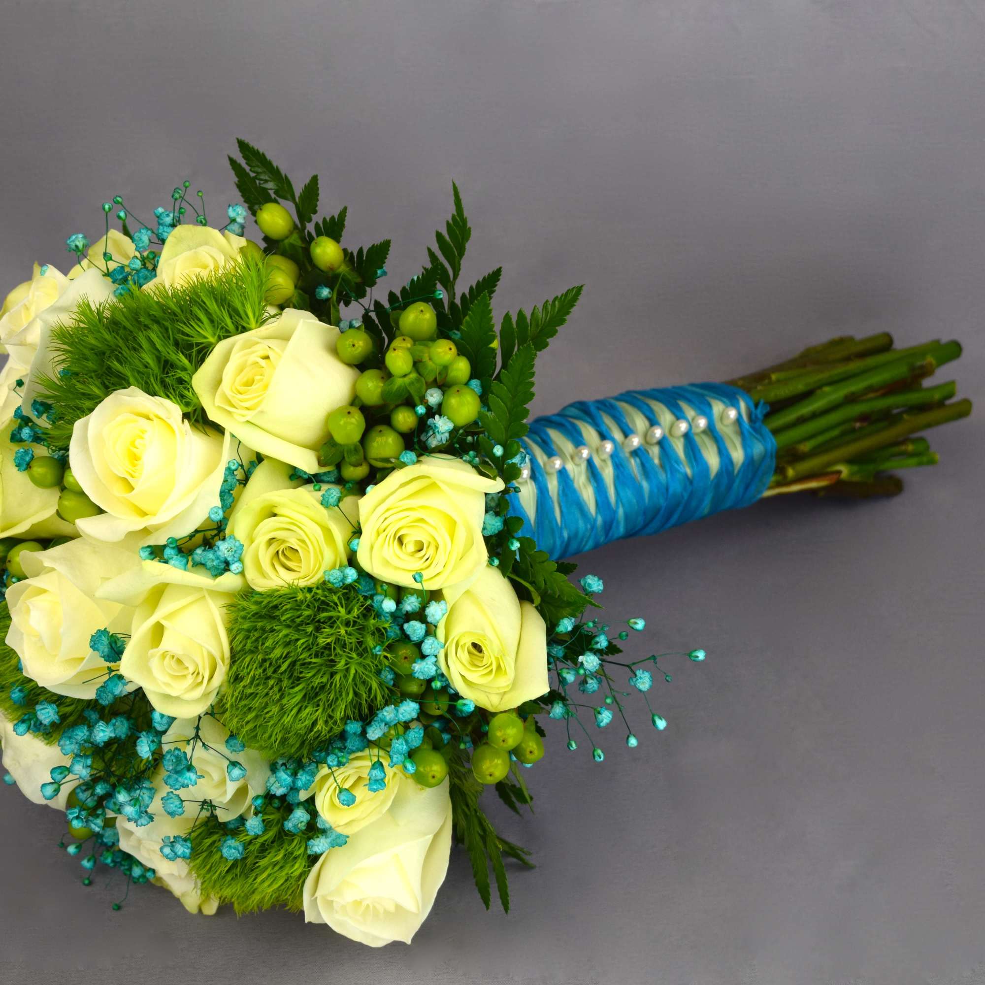 Bouquet of pale yellow roses with blue accents and a wrapped handle, photo 2 of 2