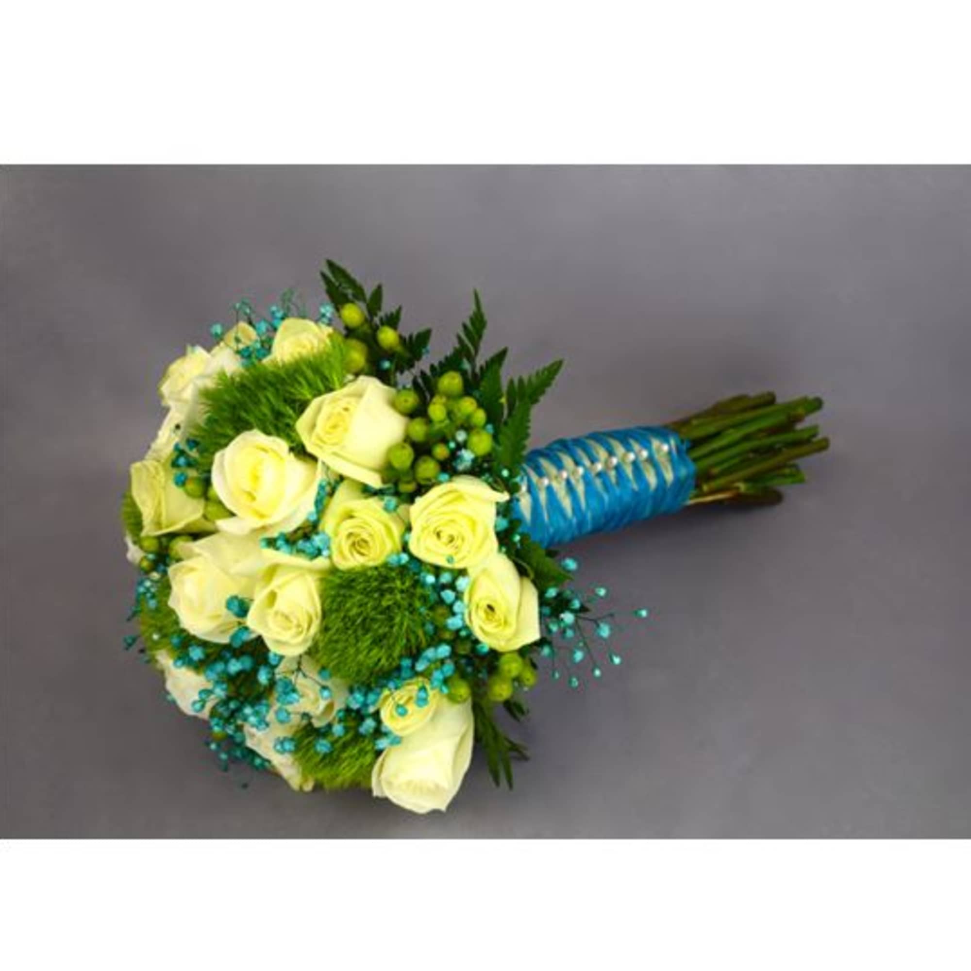 Bouquet of pale yellow roses with blue accents and a wrapped handle
