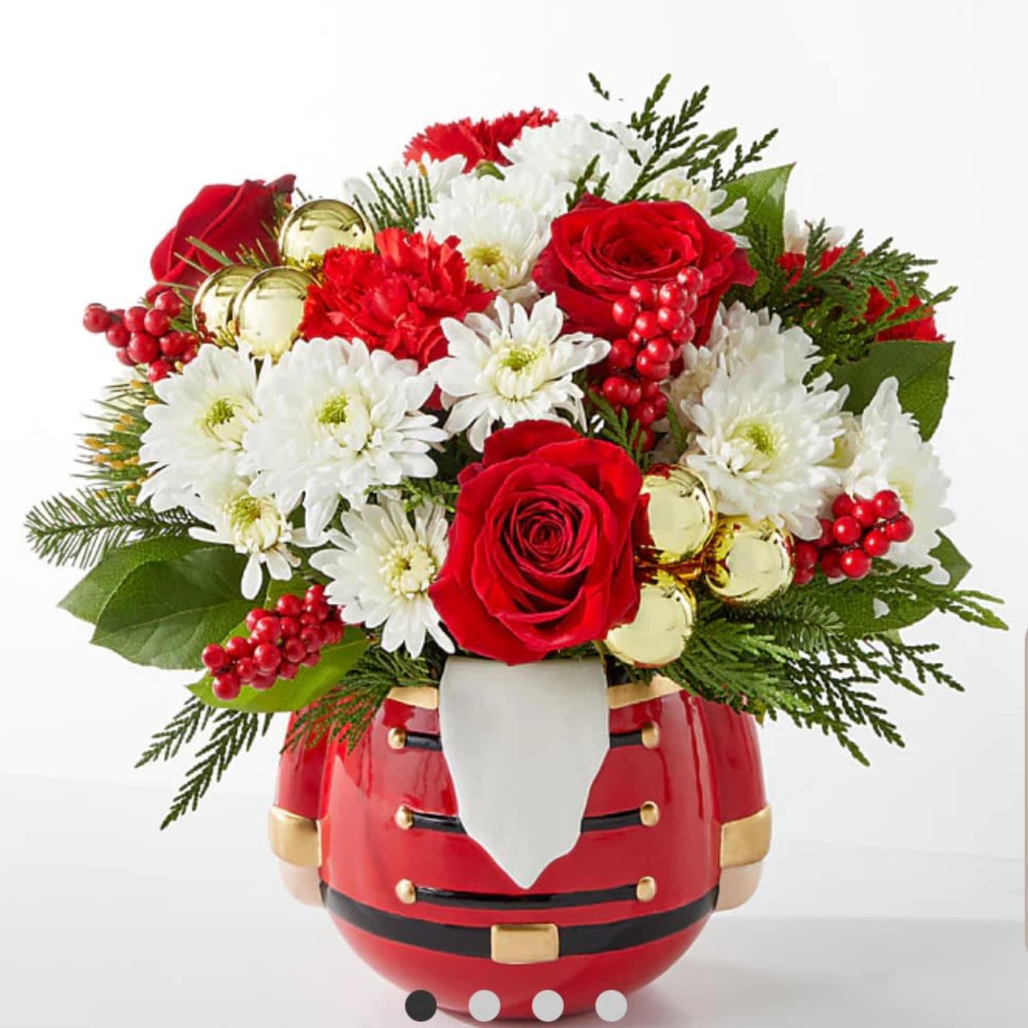 Red roses and white daisies in a Santa-shaped vase