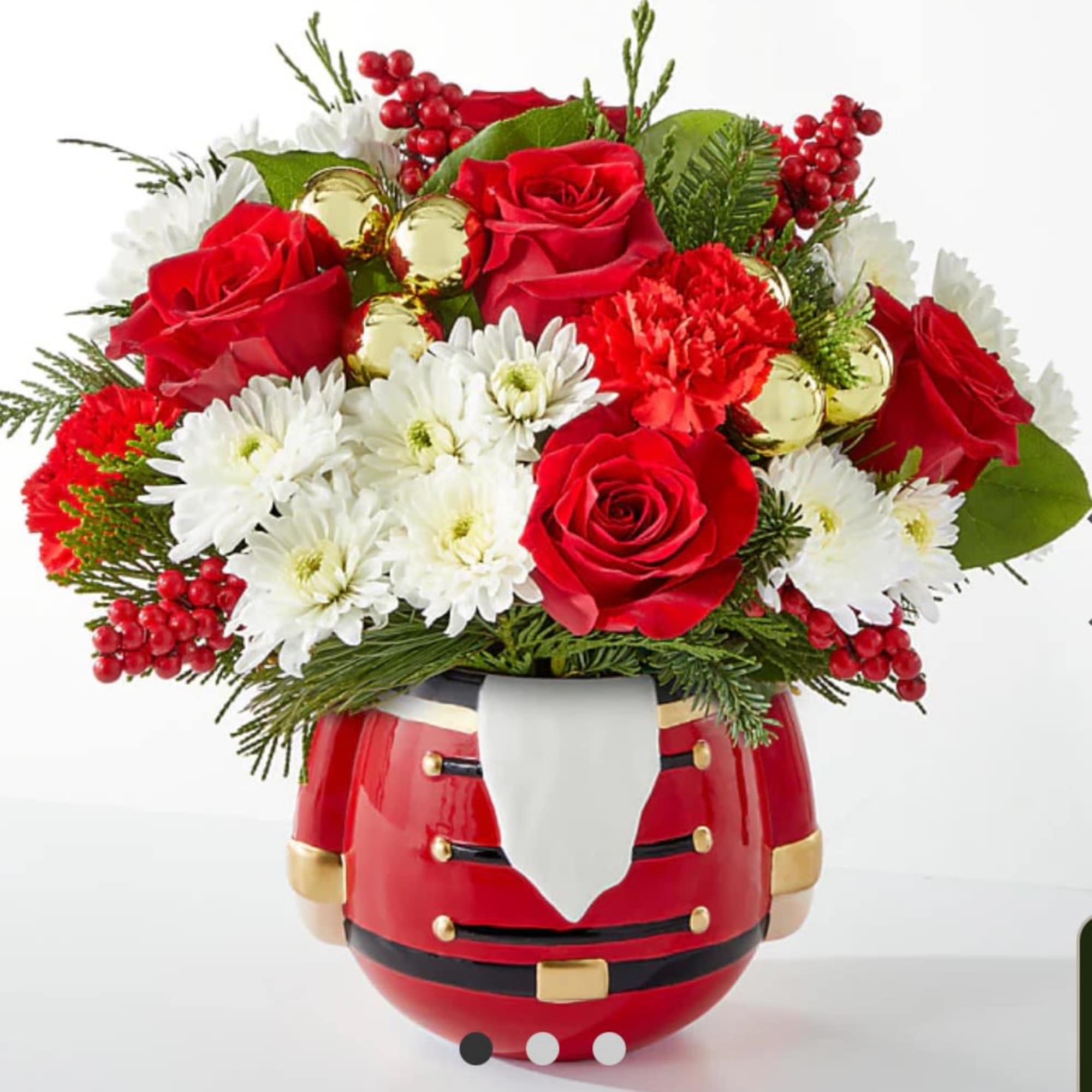 Red roses and white daisies arranged in a Santa-shaped vase
