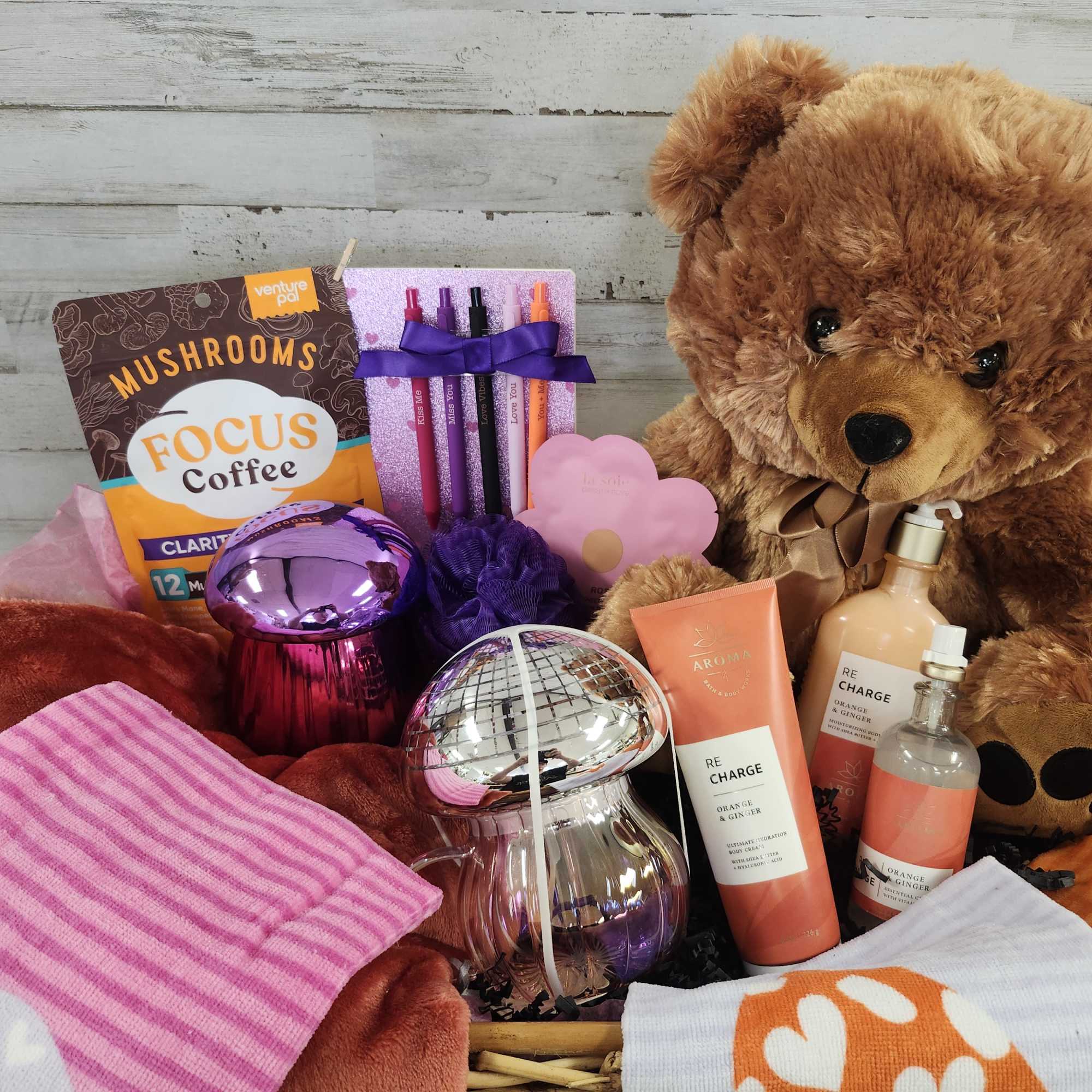 Gift basket with a teddy bear, coffee items, and colorful accessories