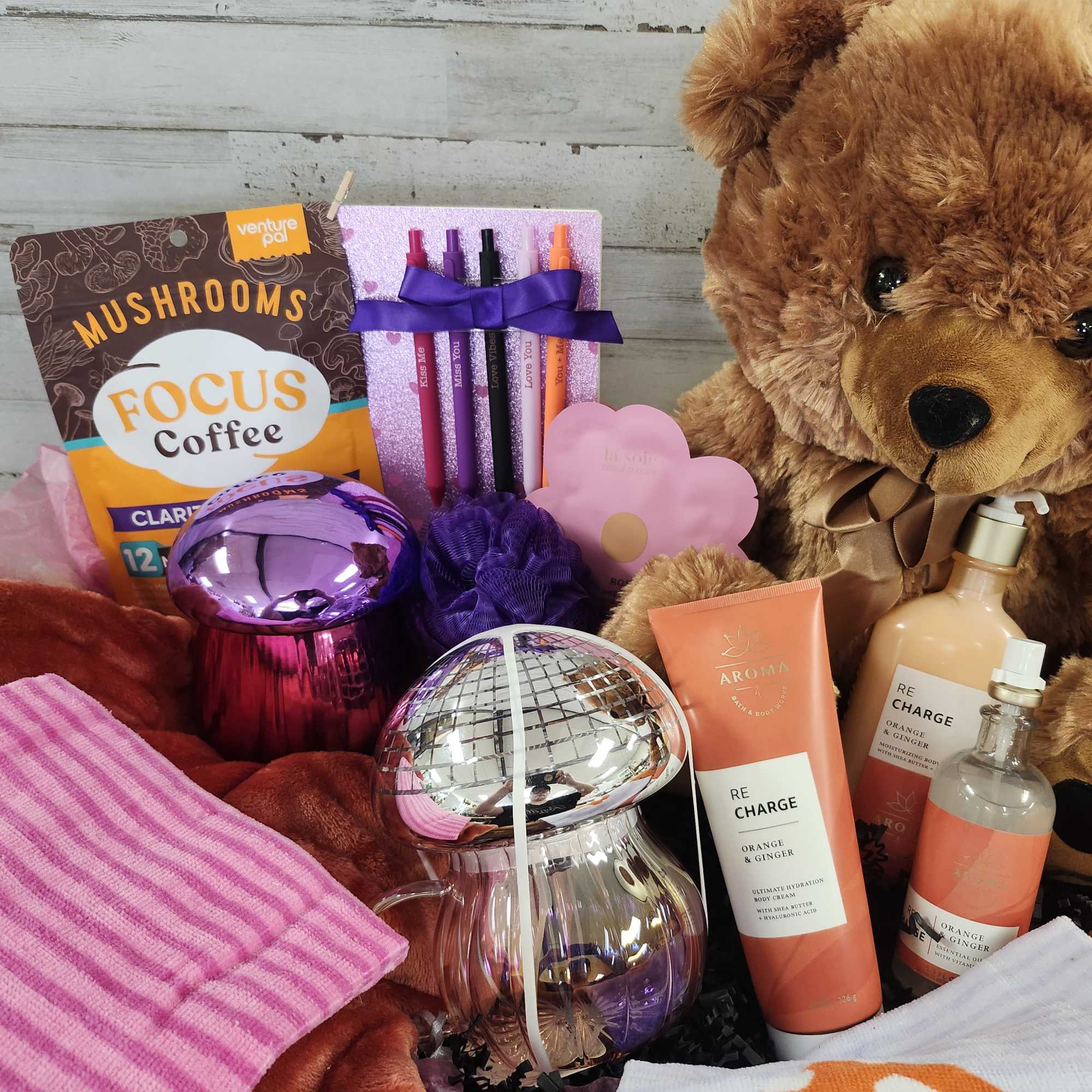 Gift basket with teddy bear, coffee, candles, and bath products