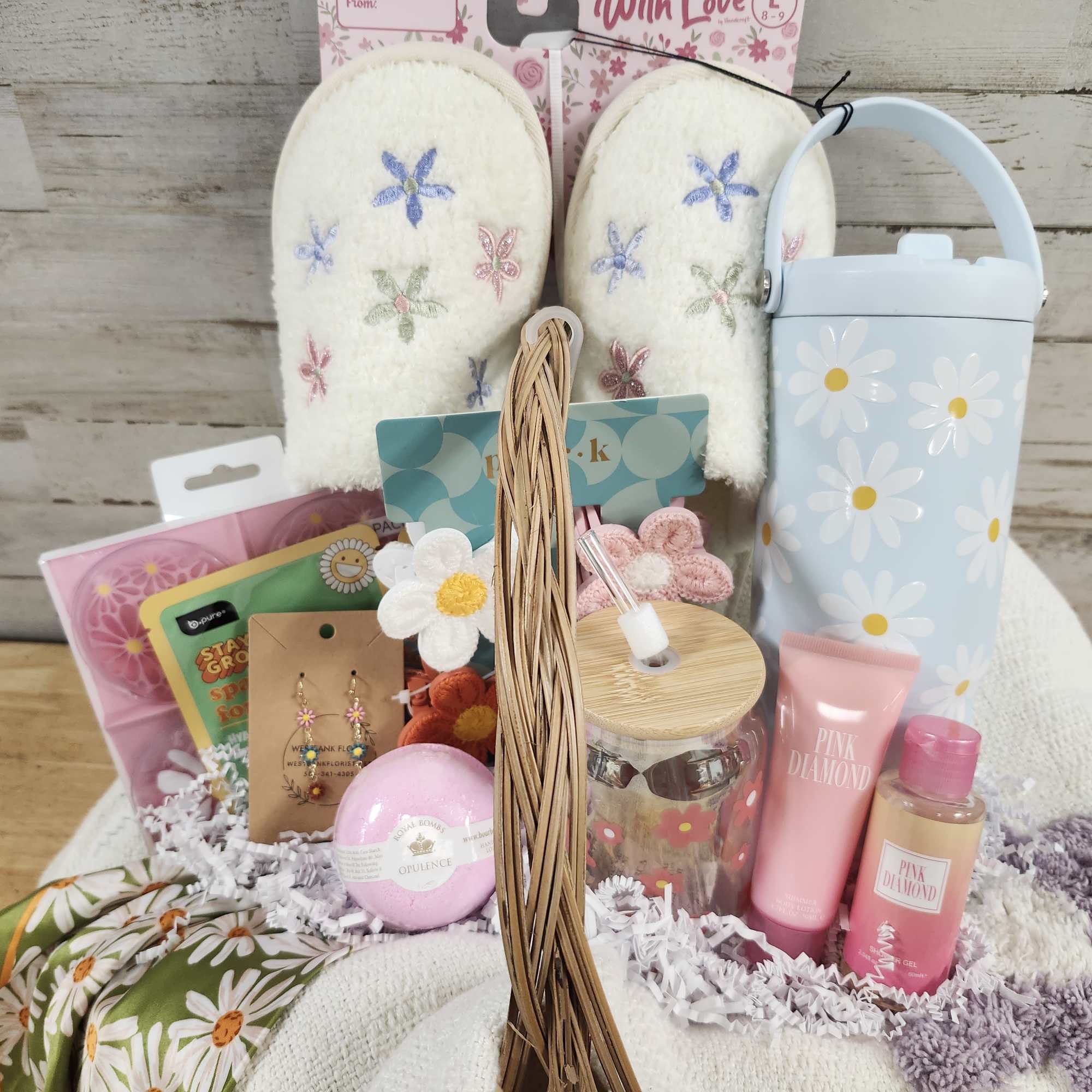 Gift basket with slippers, toiletries, and daisy-patterned items