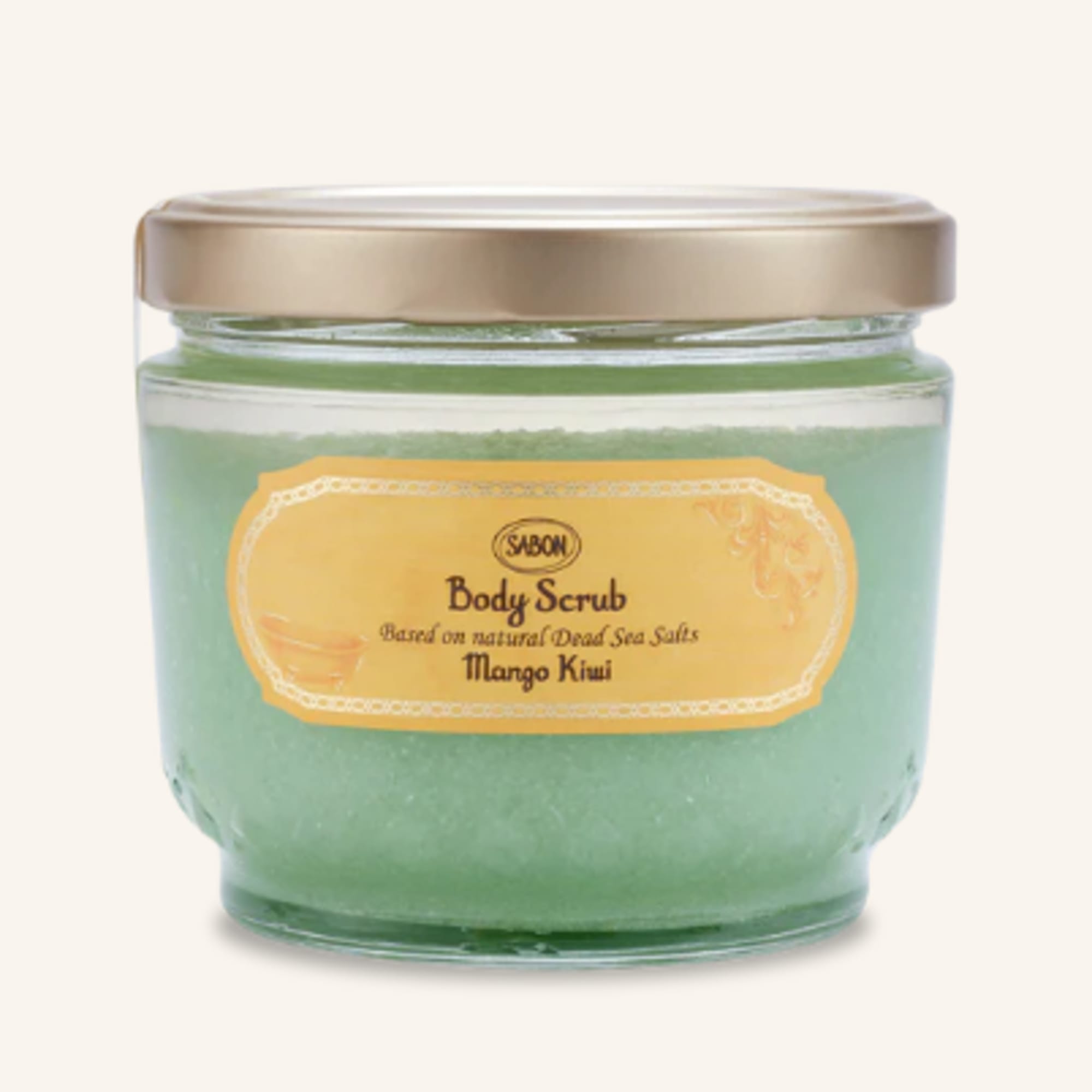 Jar of green body scrub with a gold lid