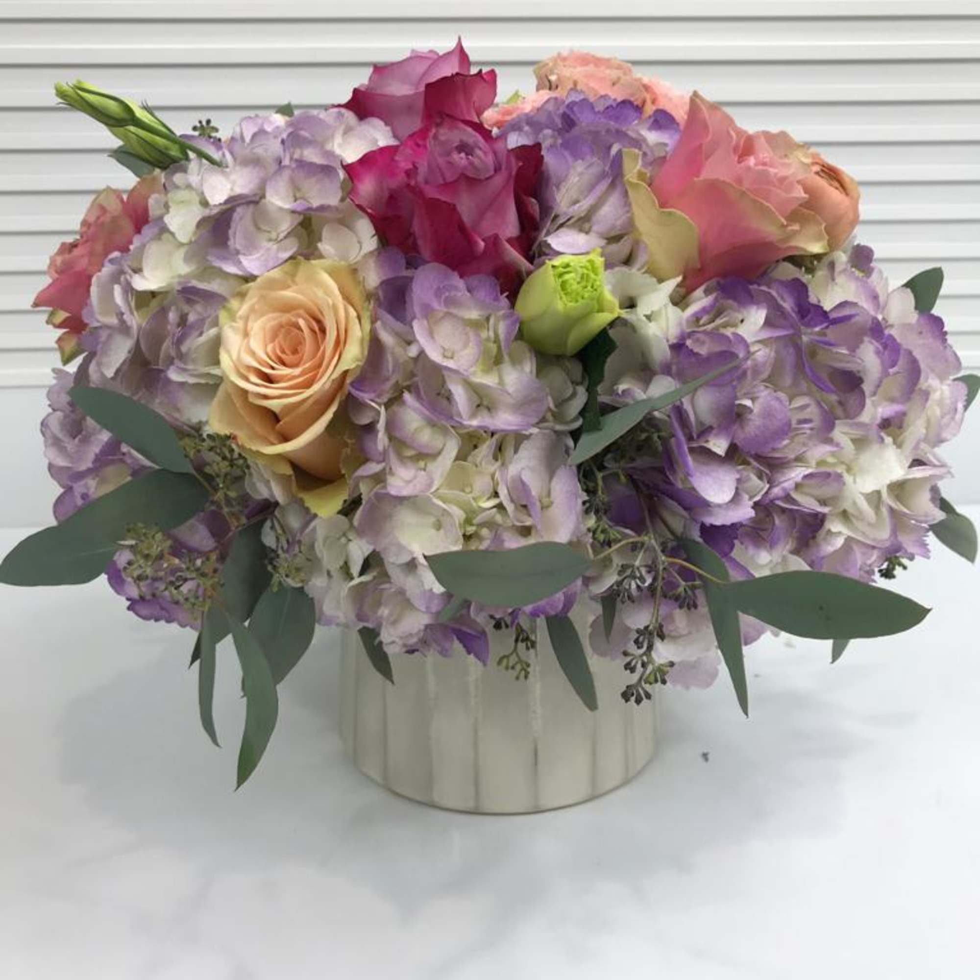 Collection of soft pastel colors in a beautiful pearl tone ceramic vase.