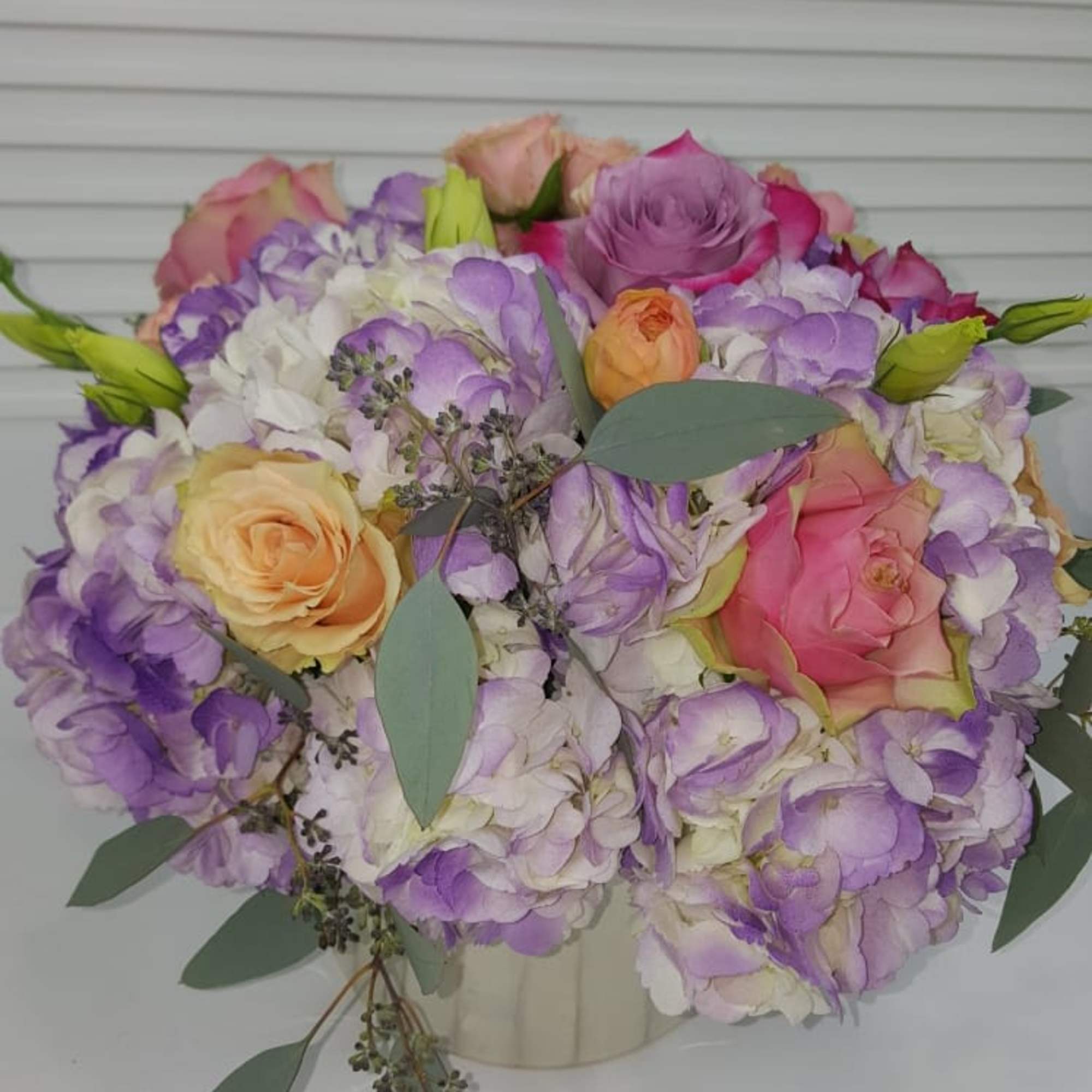 Collection of soft pastel colors in a beautiful pearl tone ceramic vase., photo 2 of 2