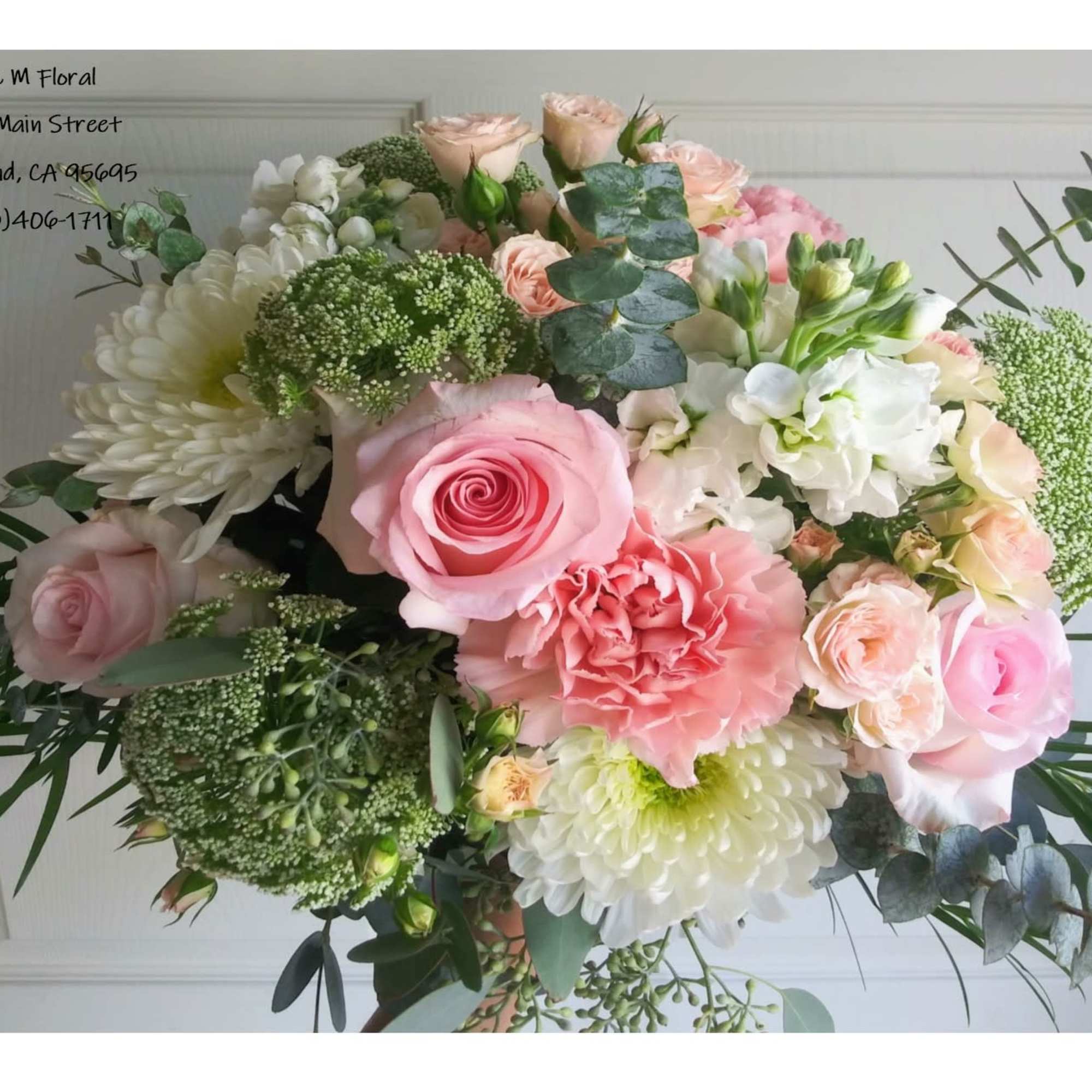 Bouquet of pink and white flowers with greenery