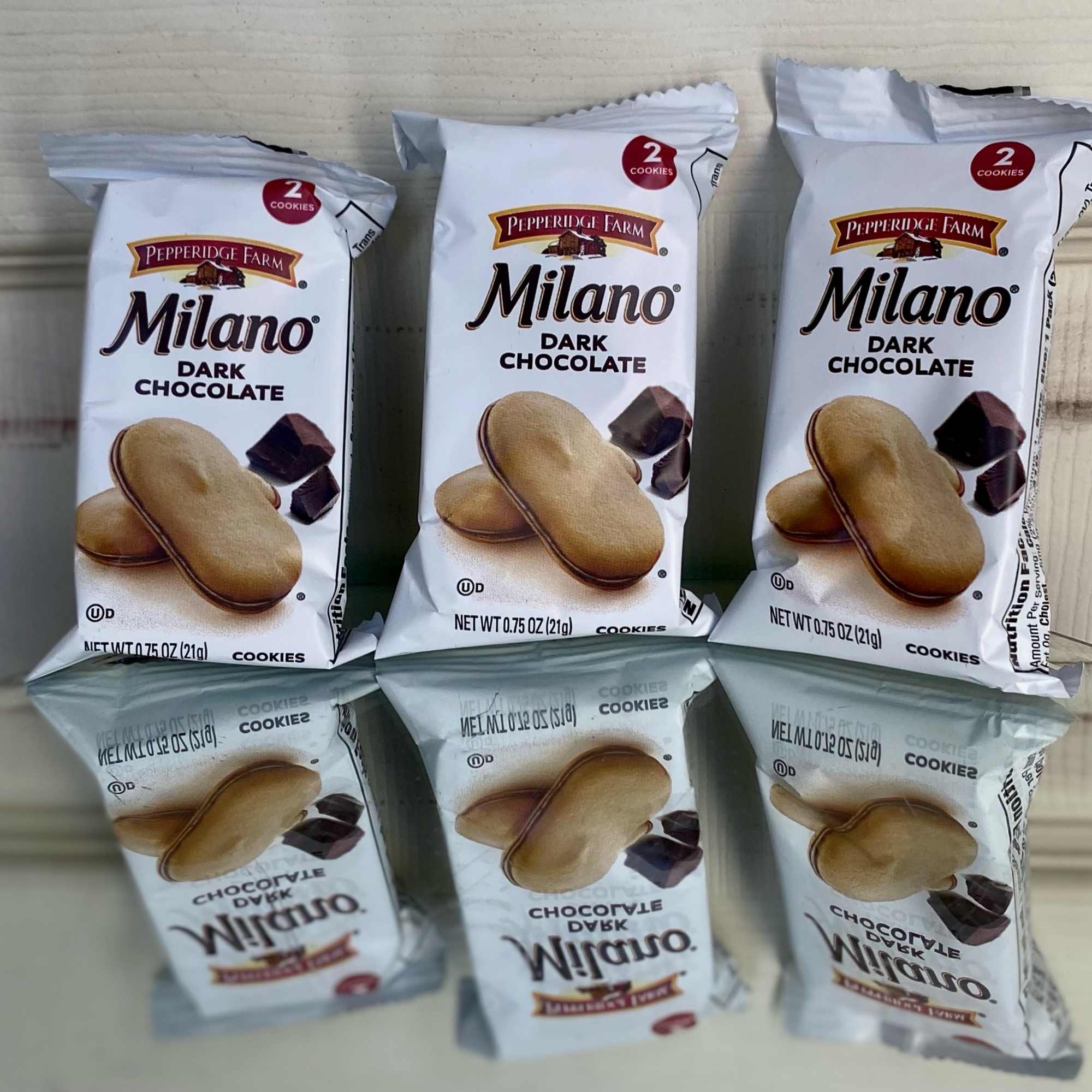 Six Pepperidge Farm Milano dark chocolate cookie packs stacked in two rows.