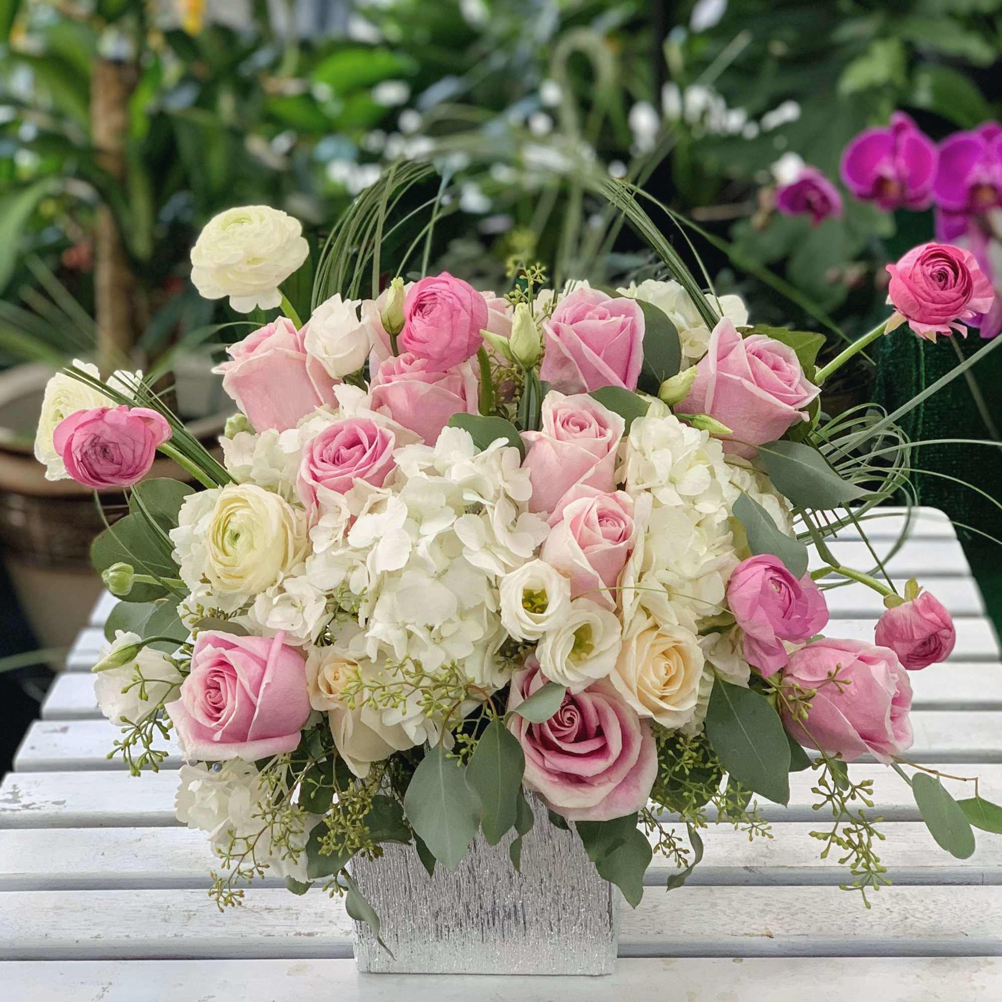 Pink roses and white hydrangeas in a silver vase