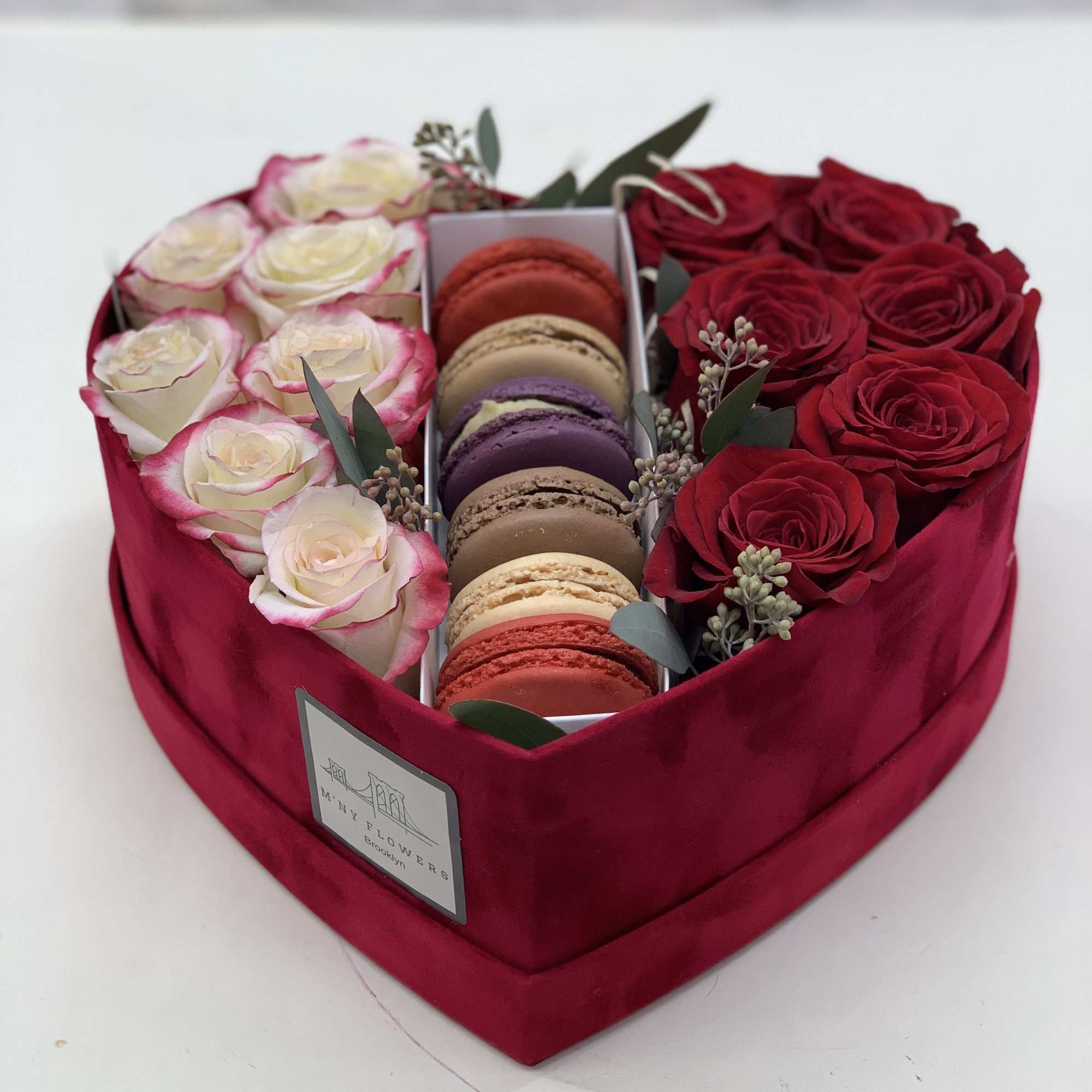 Heart-shaped box with red and white roses and macarons
