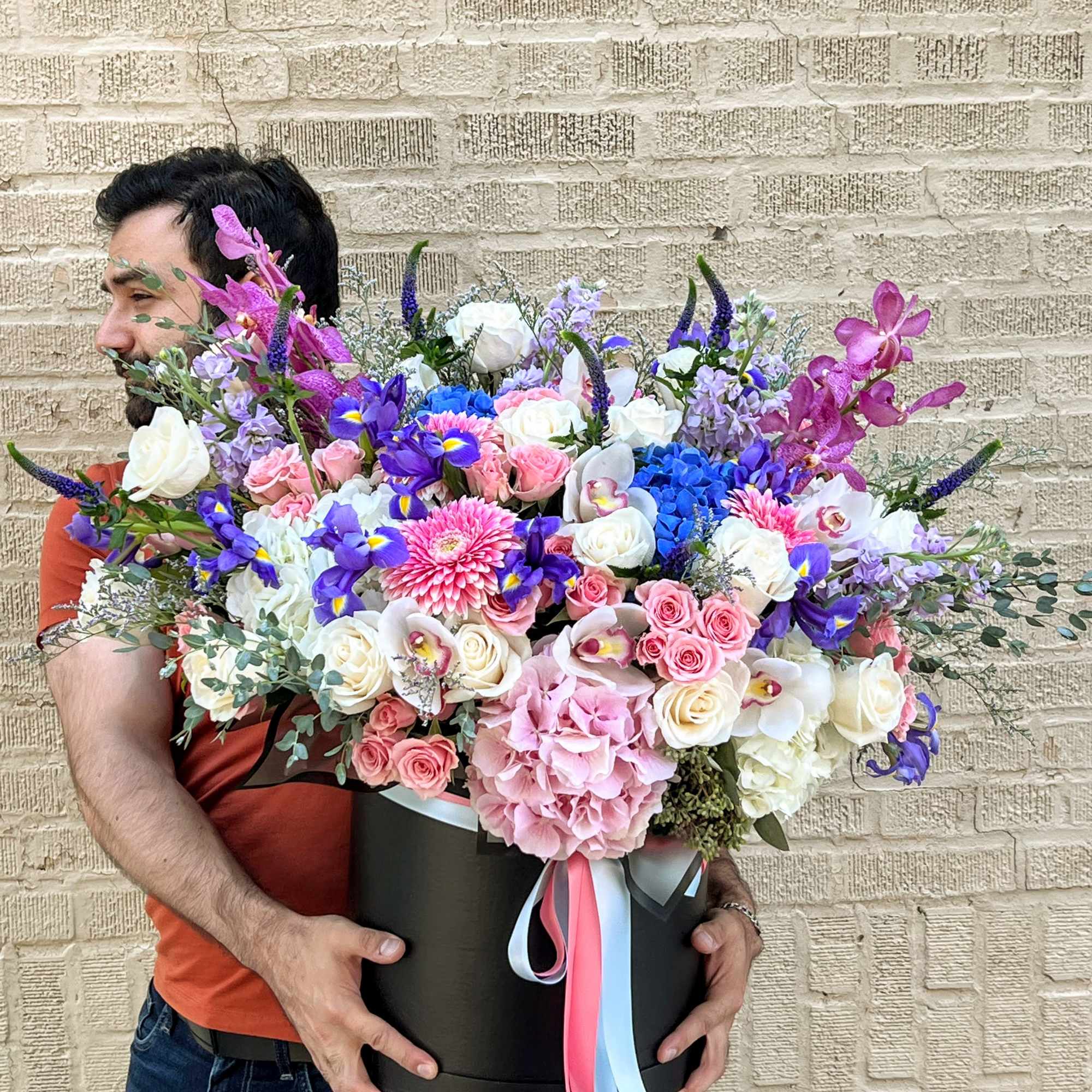 Large mixed bouquet in a black hatbox with pink, white, and purple flowers
