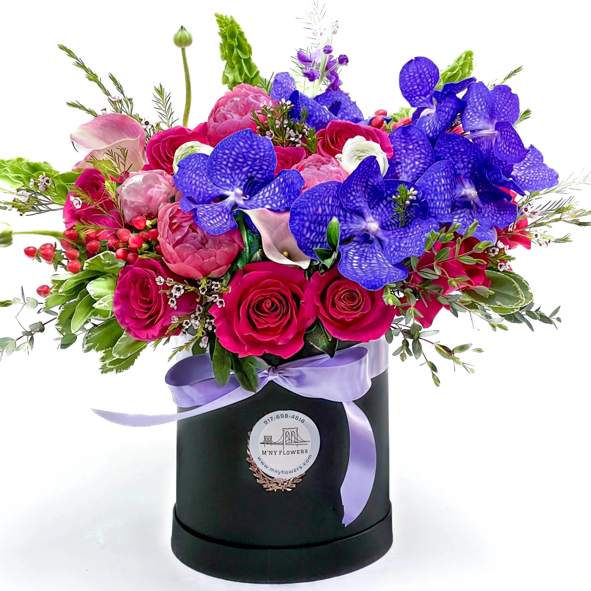 Bright mixed bouquet in a black hatbox with a lavender ribbon