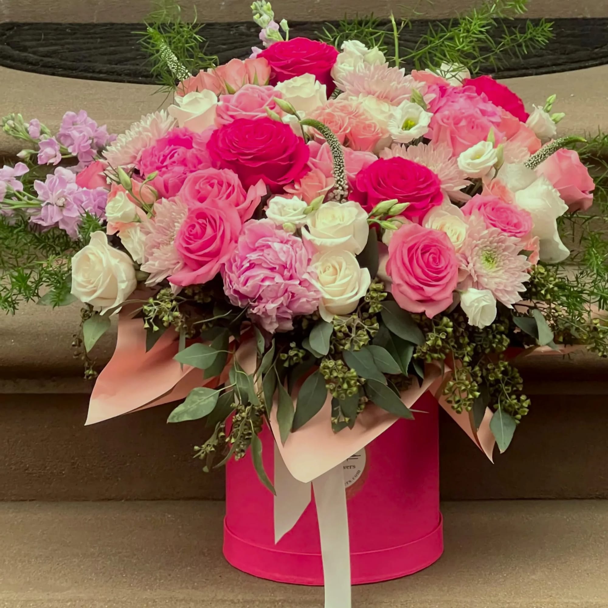Pink and white rose bouquet in a bright pink hatbox