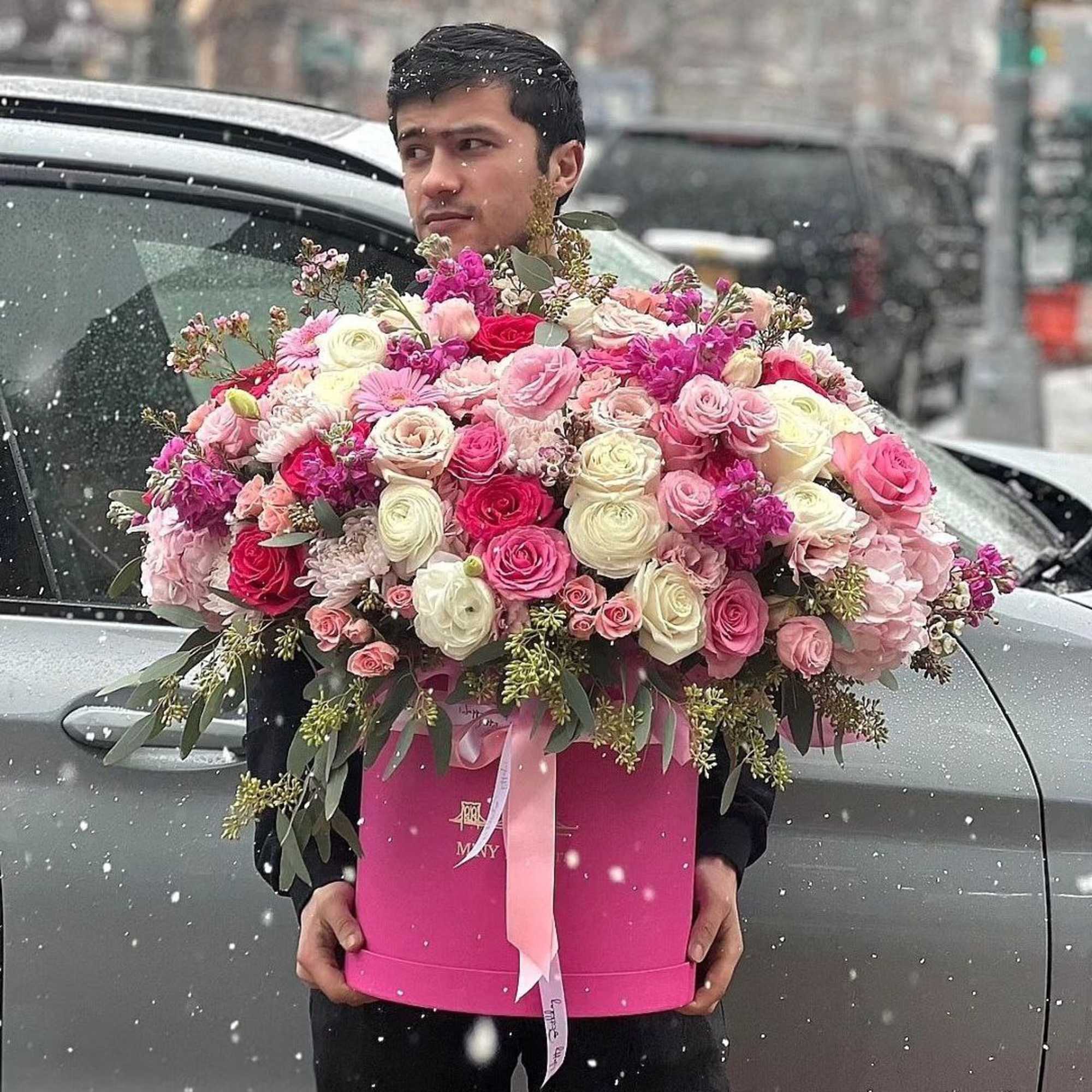 Large pink and white rose arrangement in a pink box