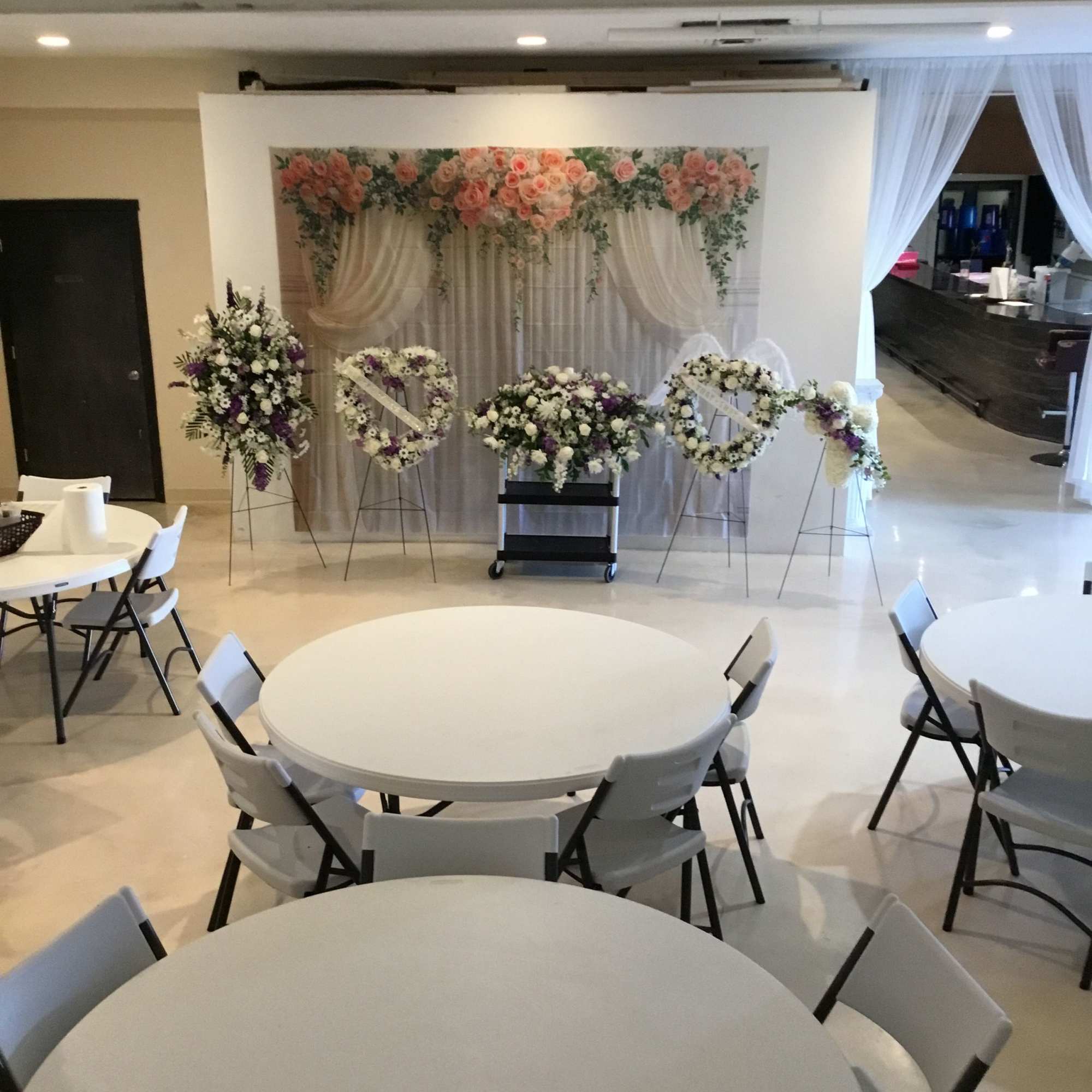 Wedding floral display with pink and white arrangements on stands