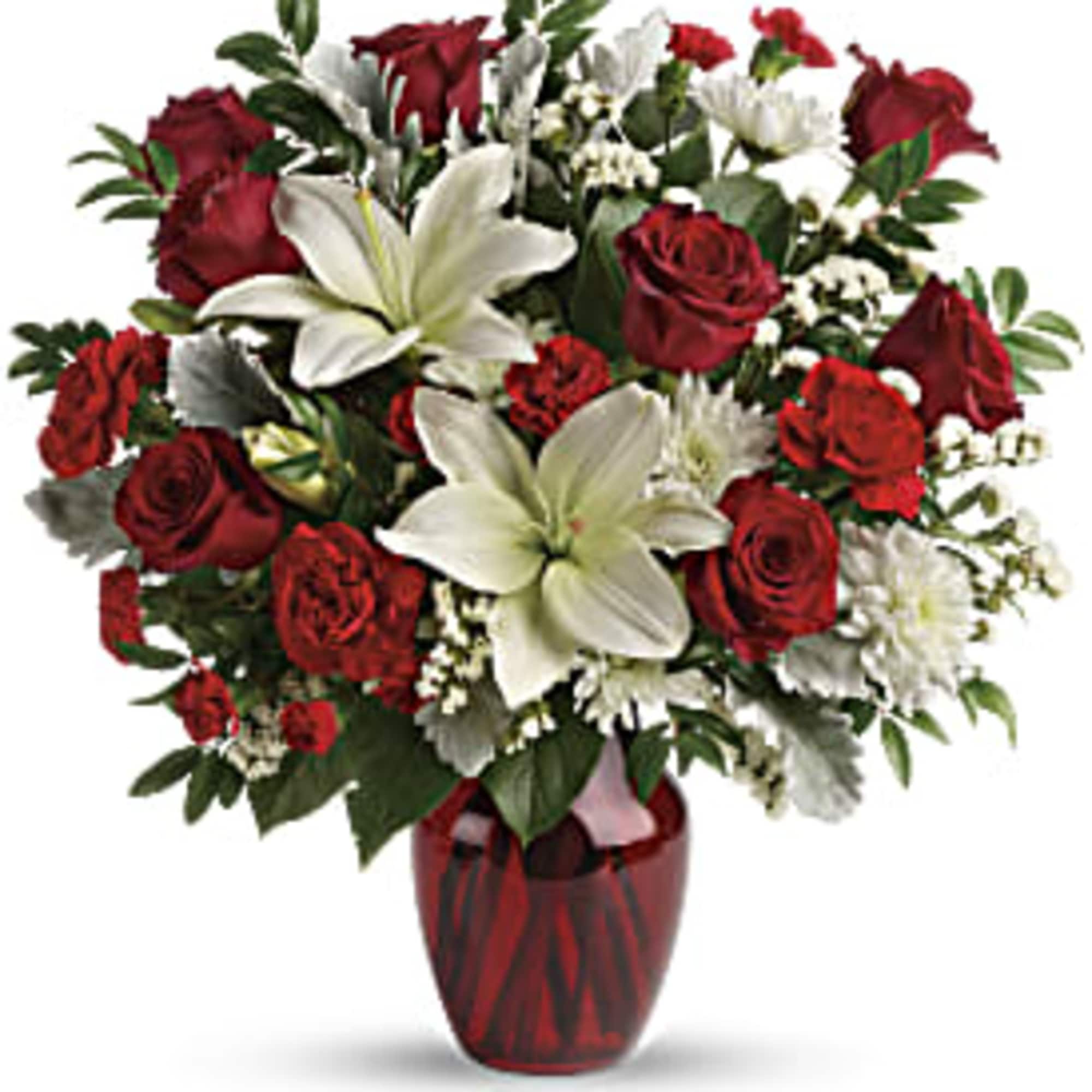 Red roses and white lilies in a red glass vase