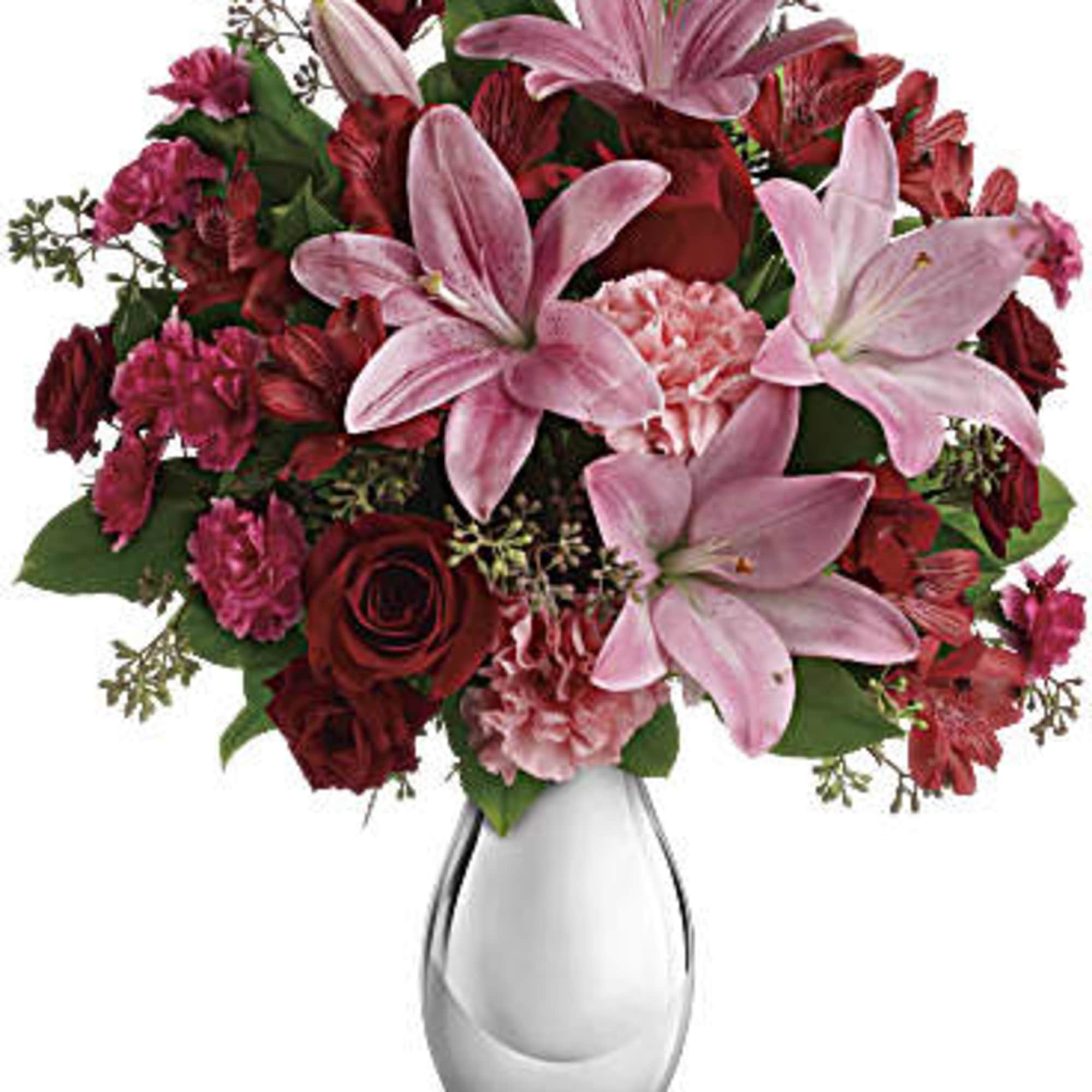 Bouquet of pink lilies and red roses in a clear glass vase