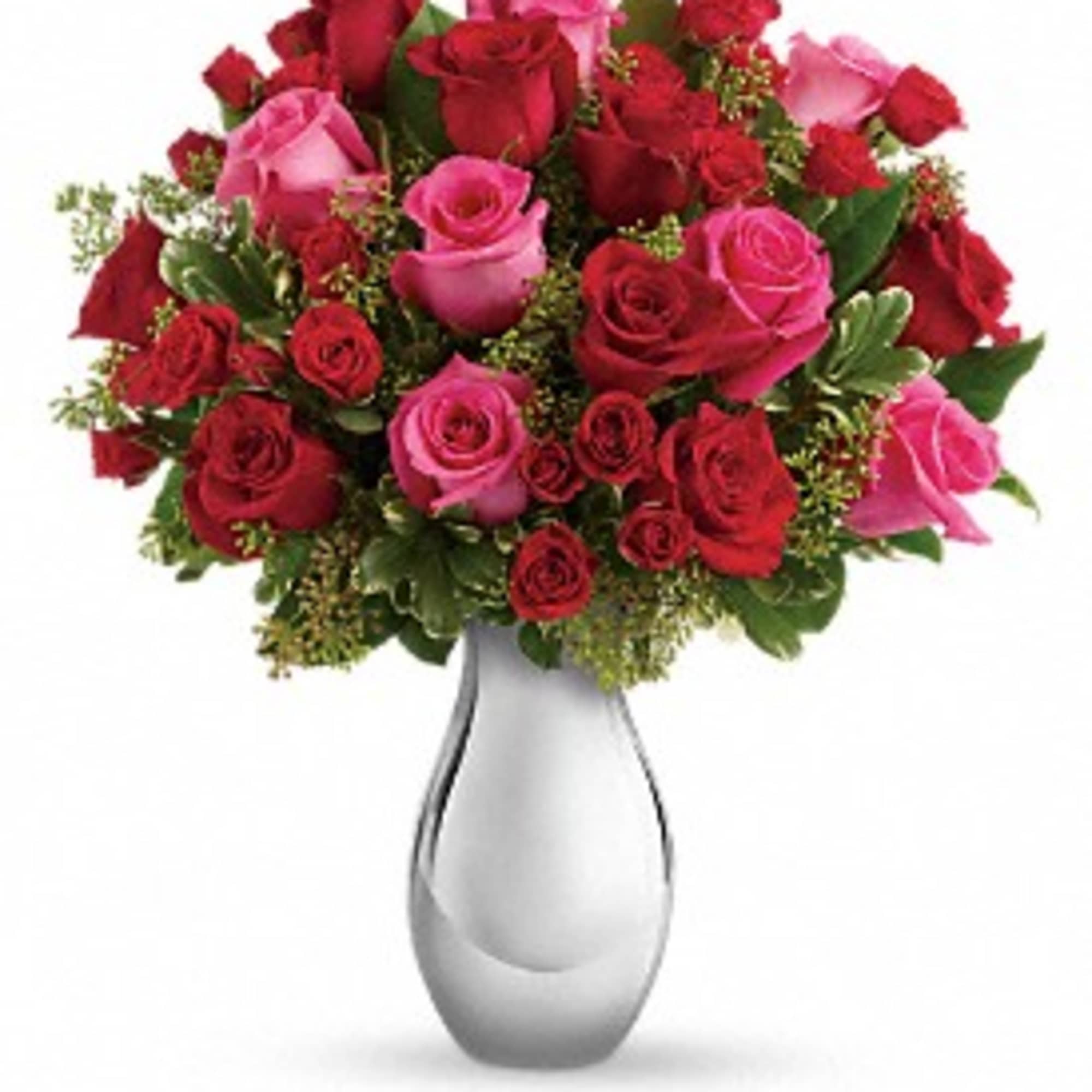 Bouquet of red and pink roses in a white vase