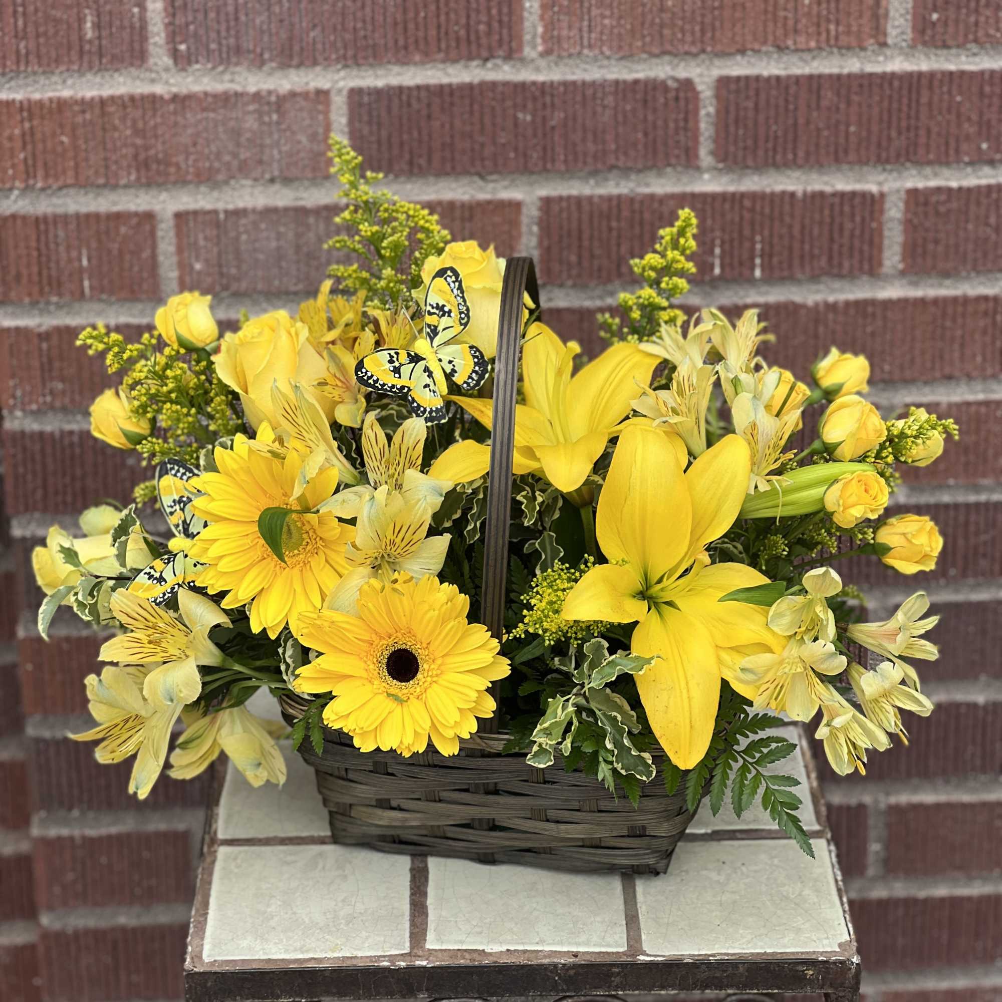 Yellow floral basket with roses, lilies, and daisies