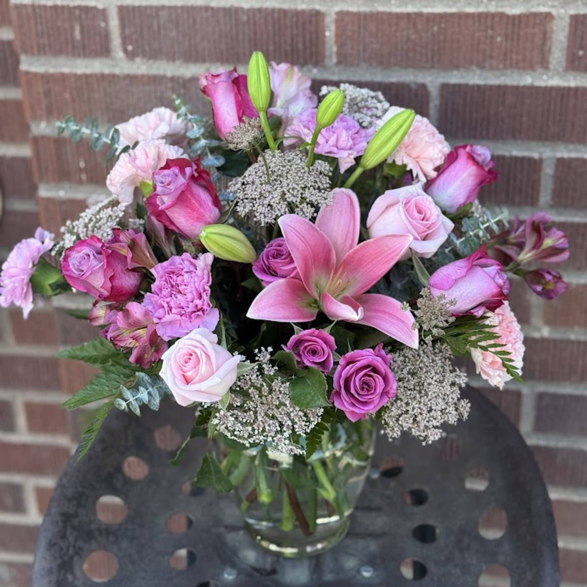 Pink and lavender mixed bouquet in a clear glass vase