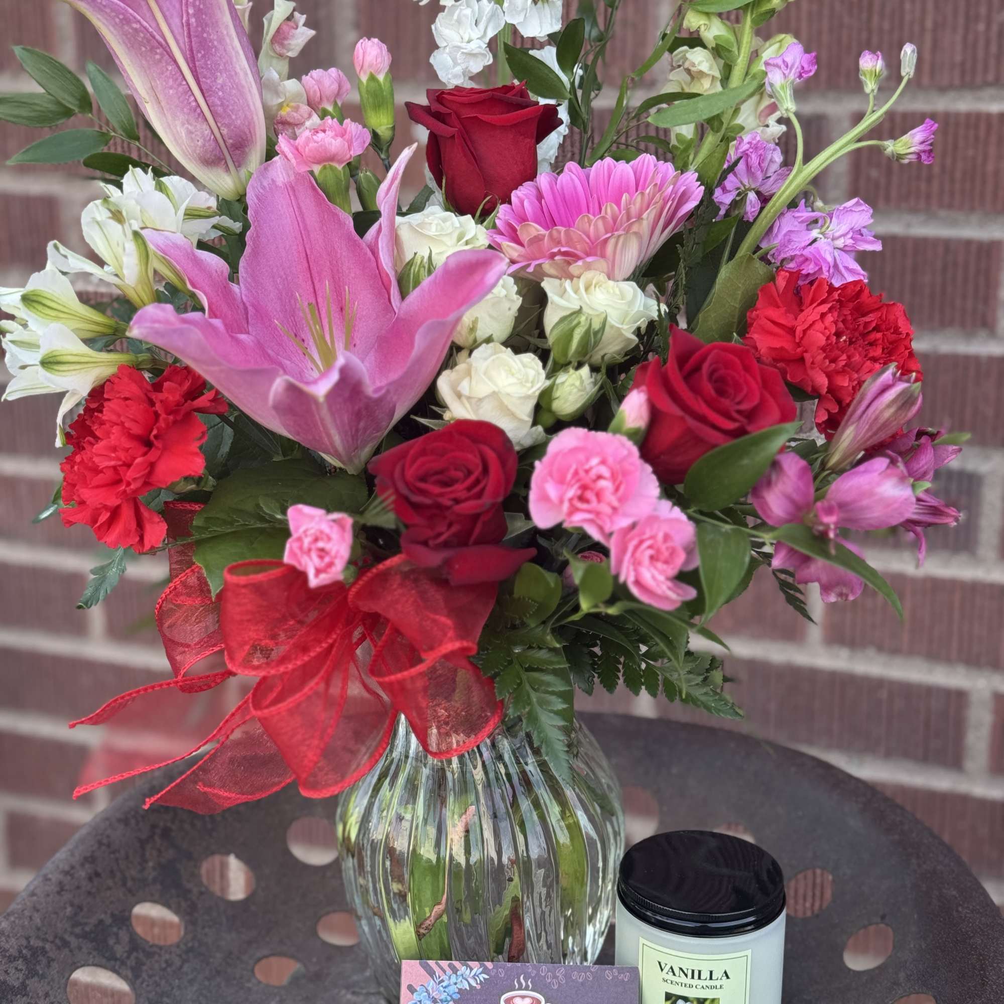 Mixed bouquet in a glass vase with a coffee gift card and vanilla candle