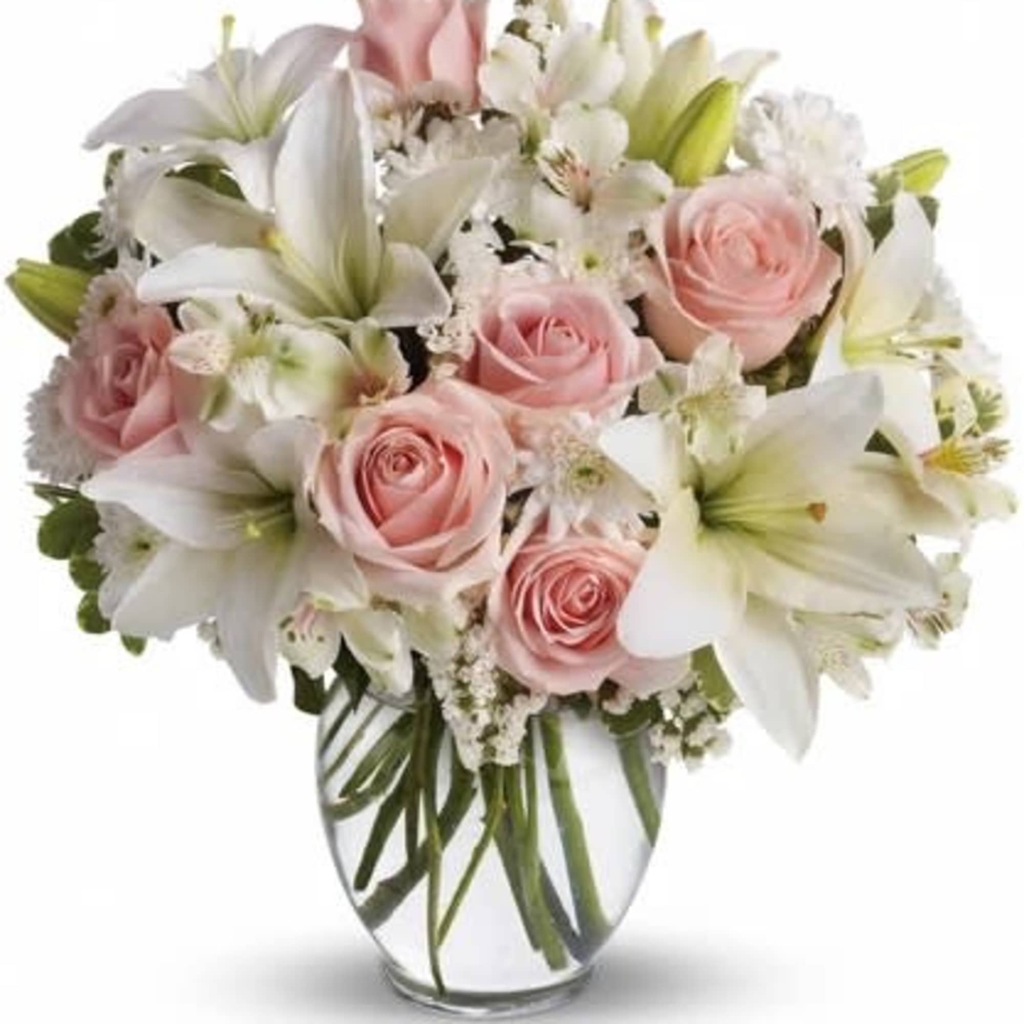 Pink roses and white lilies arranged in a clear glass vase, photo 2 of 2