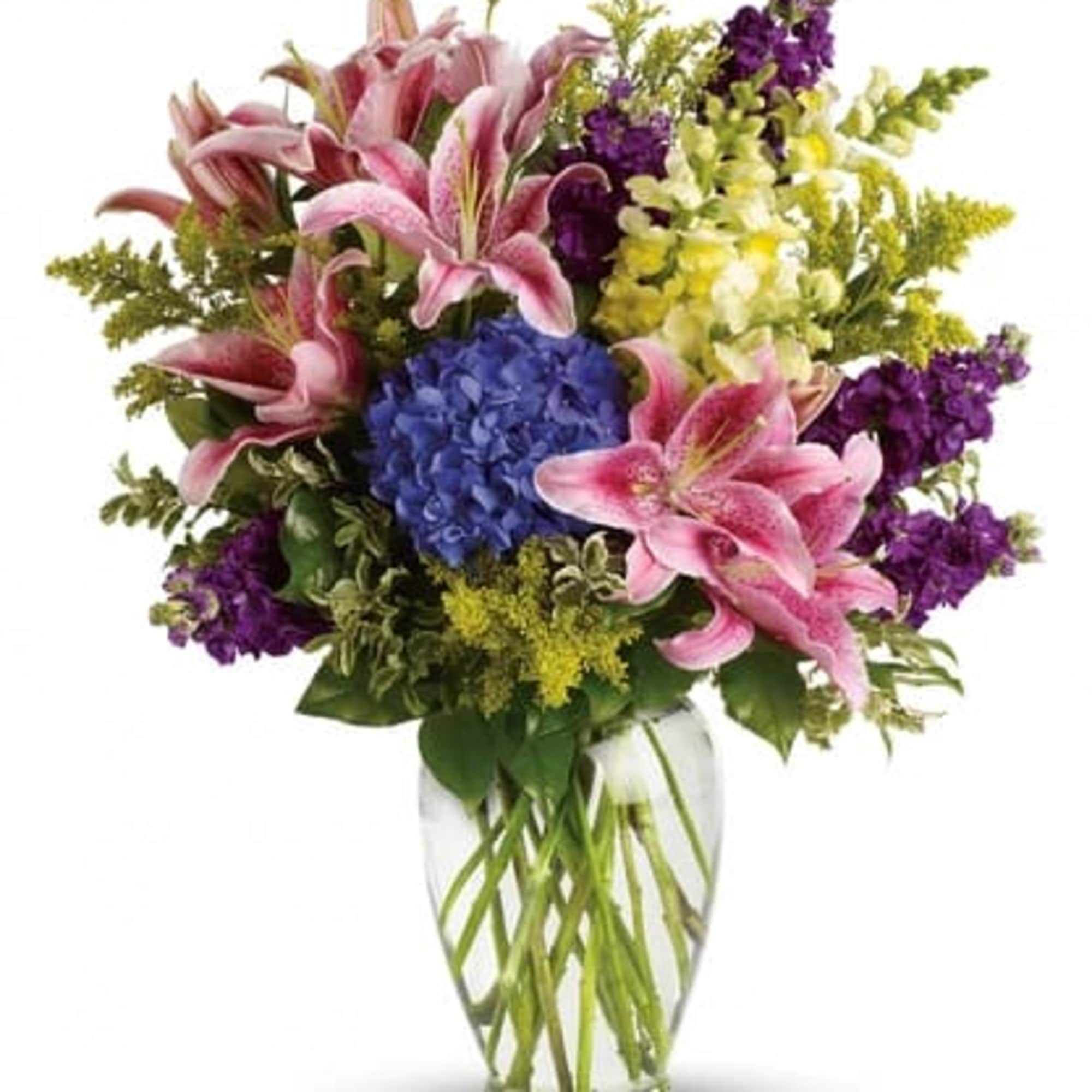 Tall bouquet of pink lilies, blue hydrangea, and mixed purple and yellow flowers in a clear glass vase