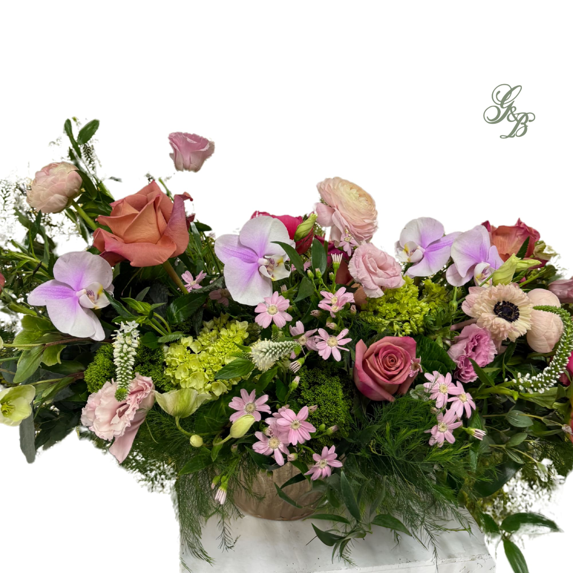 Mixed bouquet with roses, orchids, and pink blooms in a low container