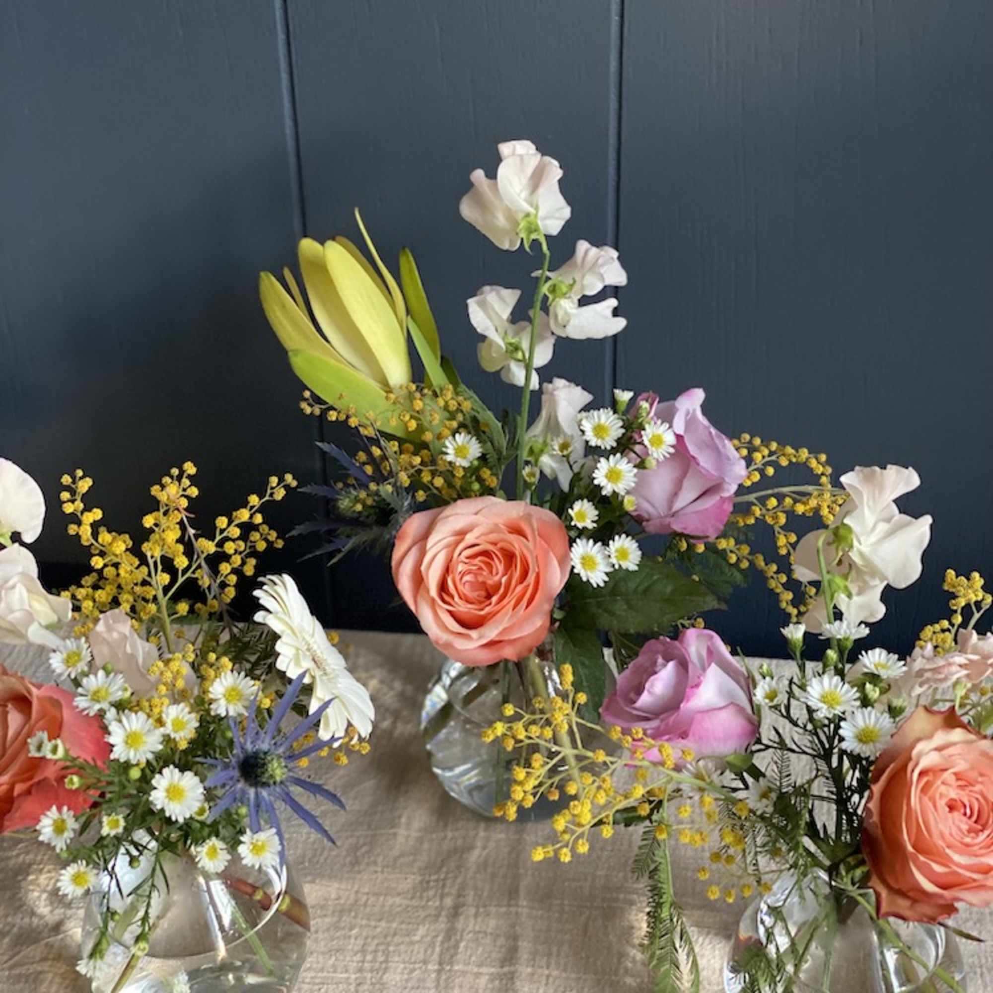 Small mixed flower arrangements in clear glass vases, photo 4 of 4
