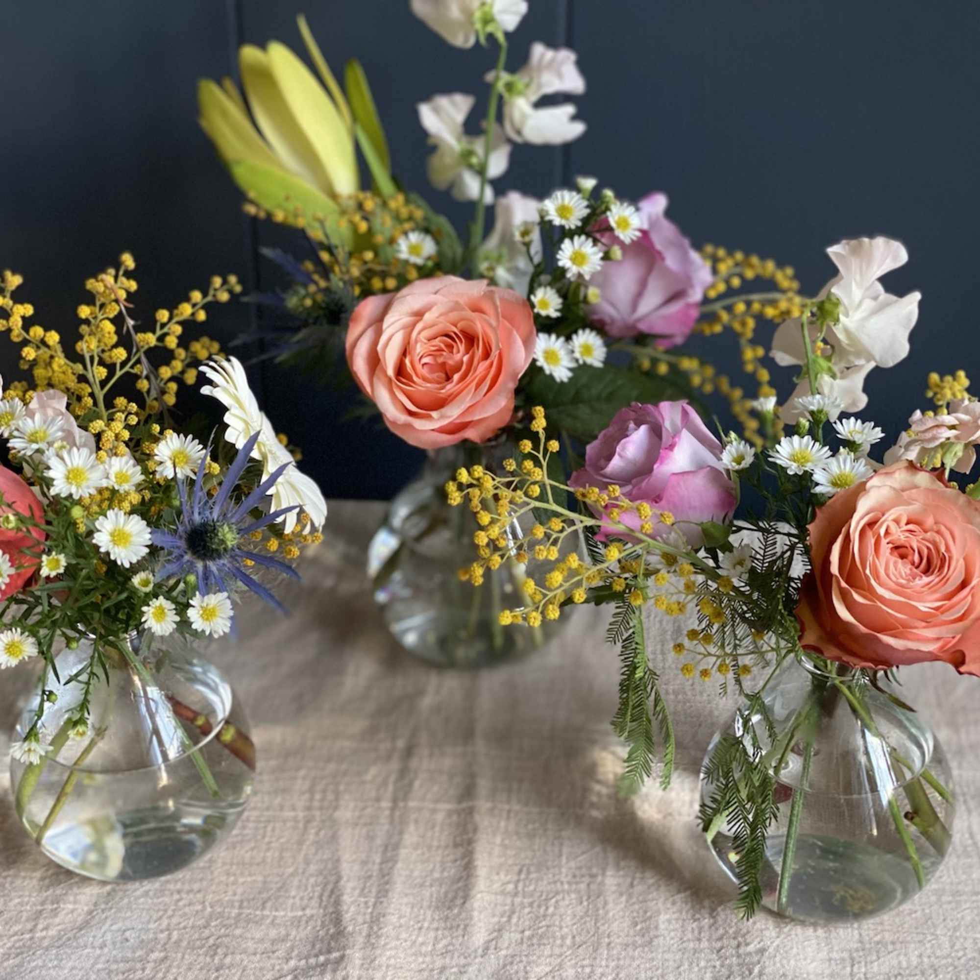 Small mixed flower arrangements in clear glass vases, photo 3 of 4