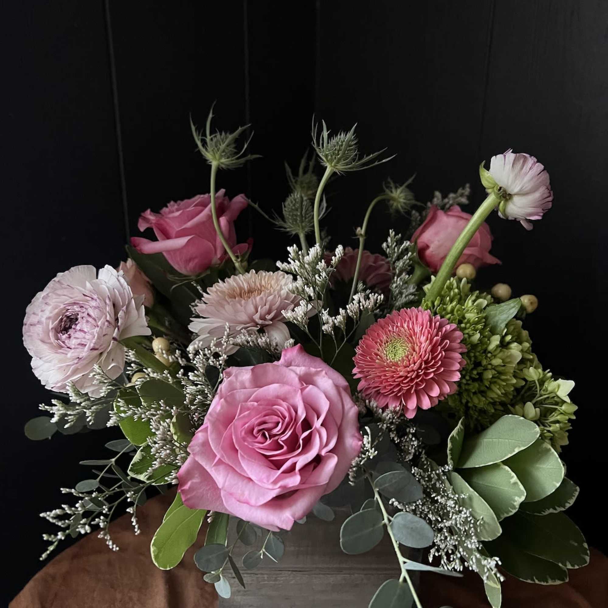 Pink roses and mixed blooms arranged in a wooden box, photo 3 of 4