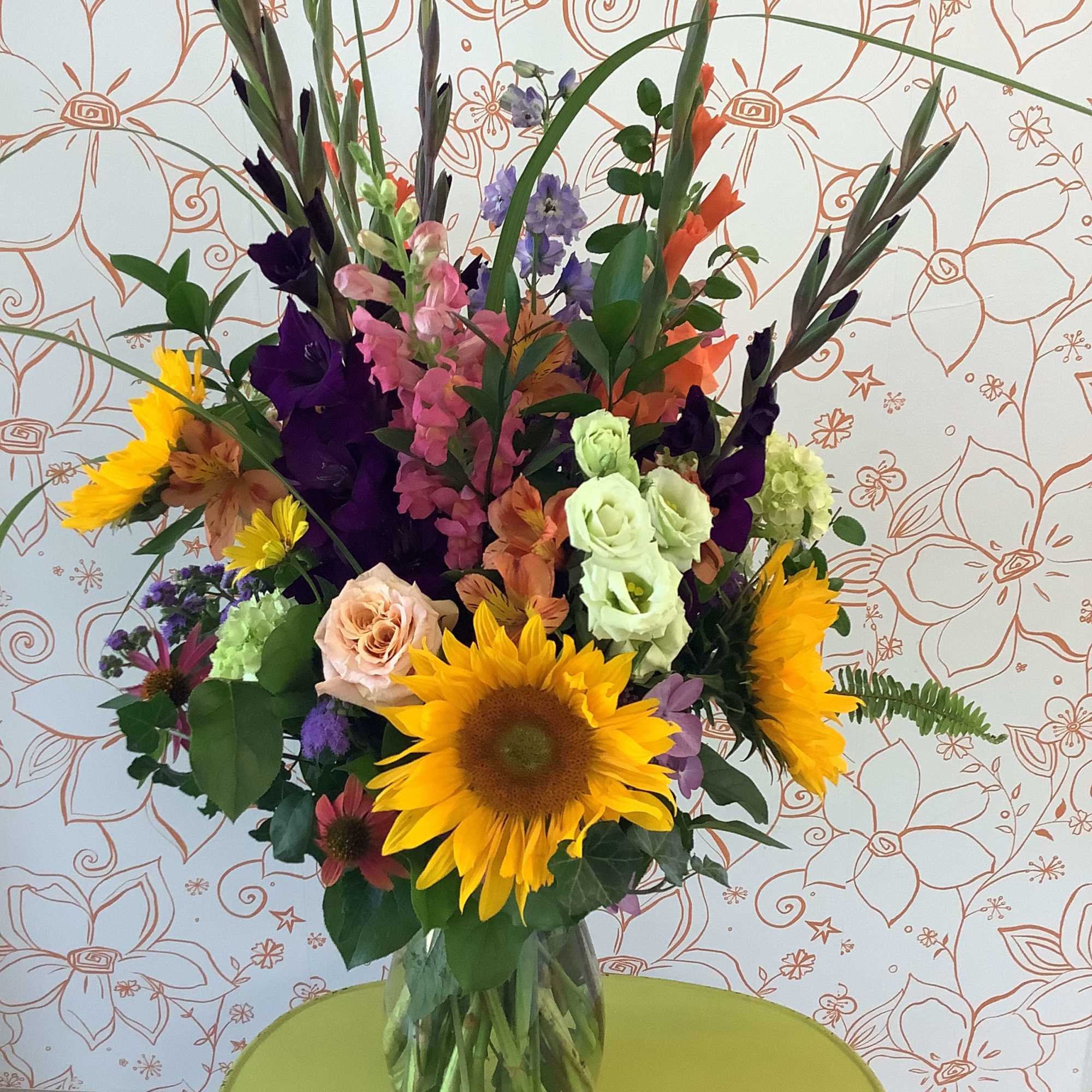 This gorgeous presentation features the brightest and blooms of the current season.