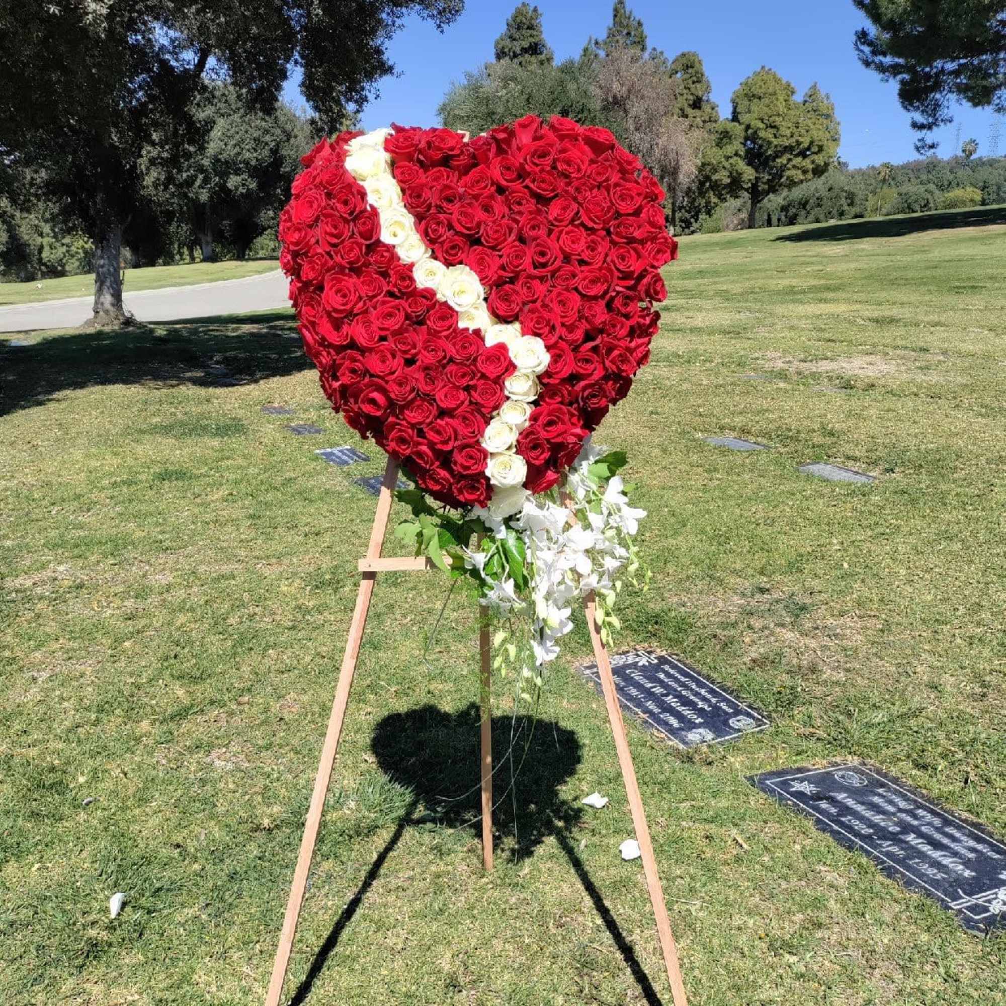 Heart-shaped rose standing spray with a white diagonal stripe