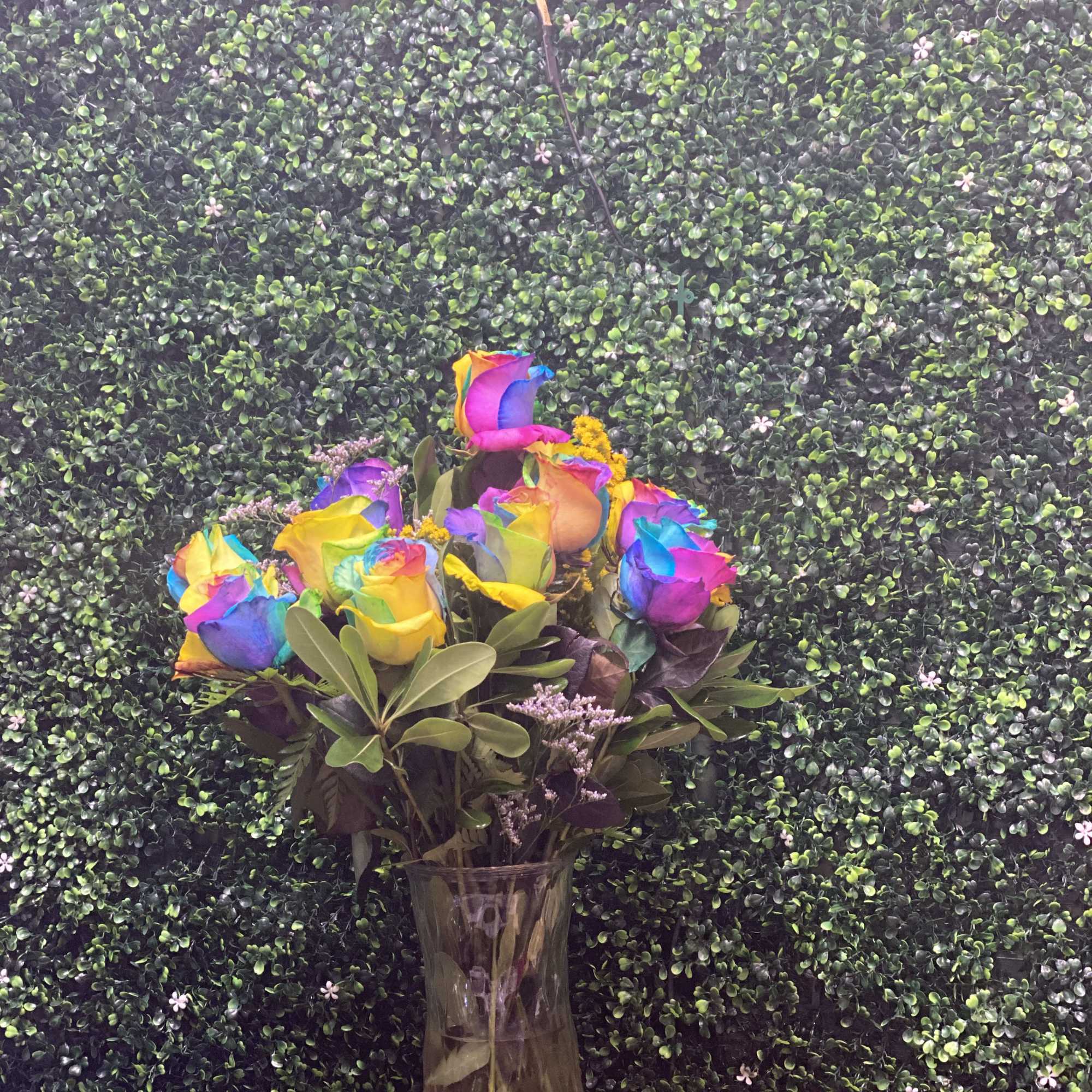 Rainbow-colored roses in a clear glass vase, photo 2 of 2