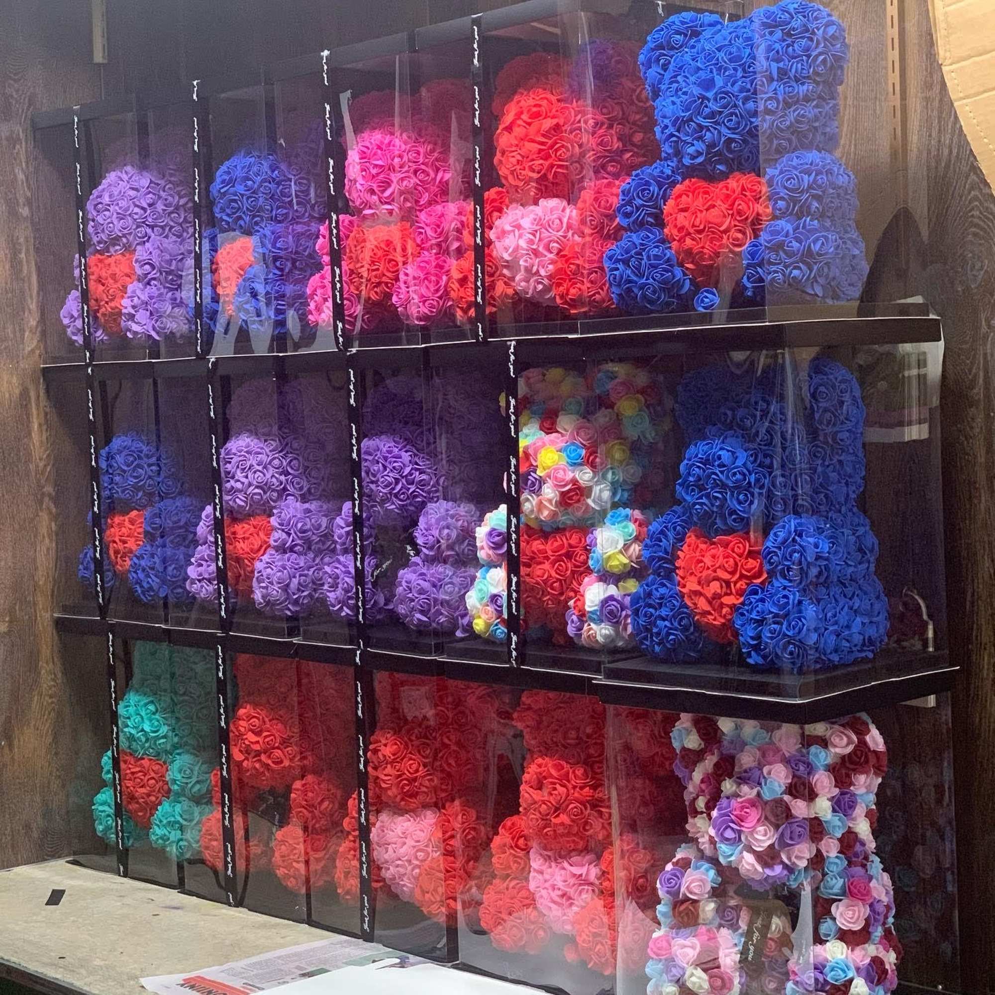 Stacked boxes of colorful rose-shaped floral arrangements
