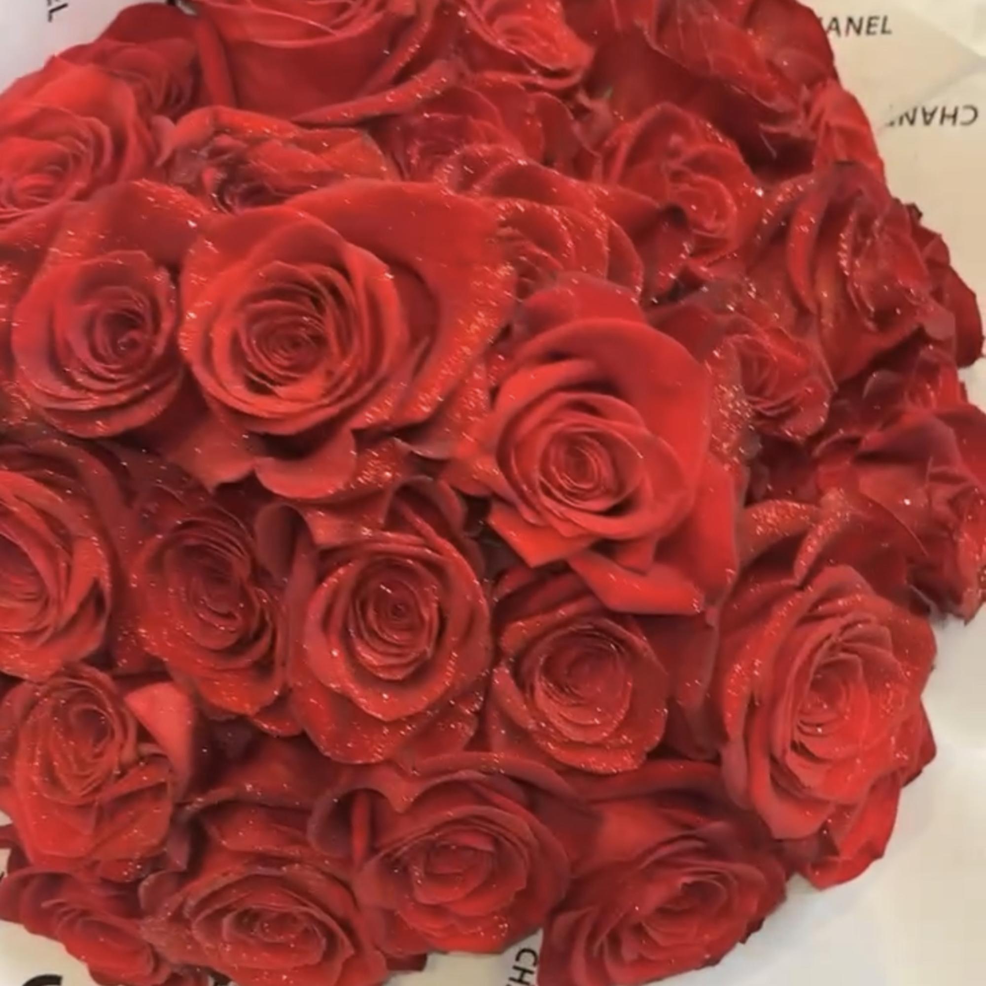 Round bouquet of red roses wrapped in Chanel paper