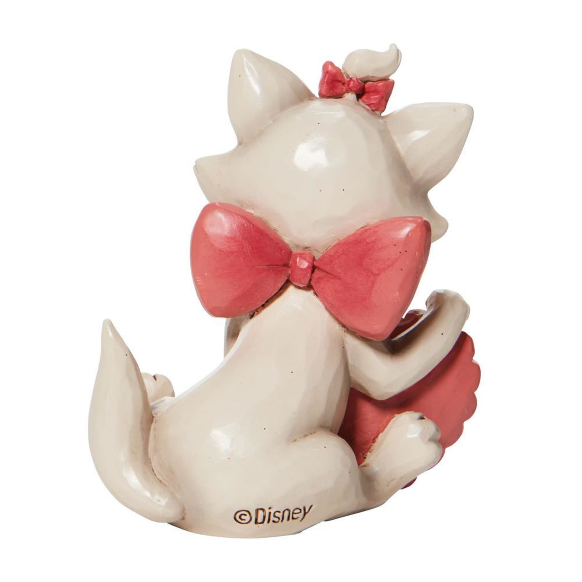 Disney figurine of a white kitten with pink bows