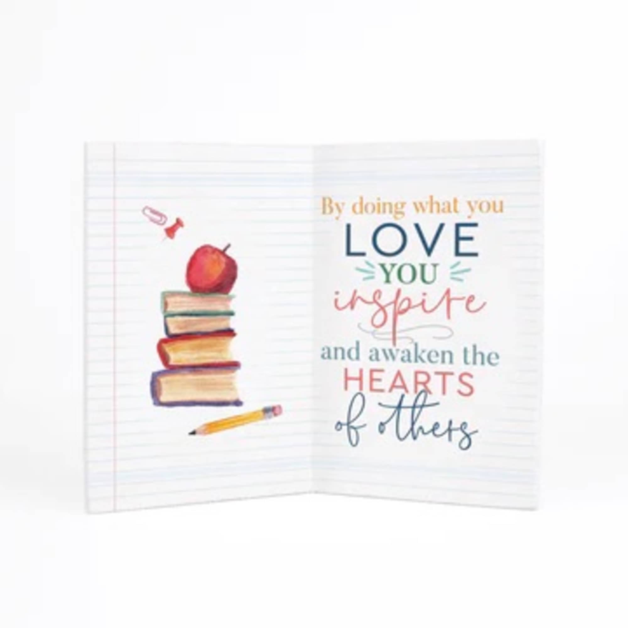 Notebook-style card with a stack of books, apple, and inspirational text
