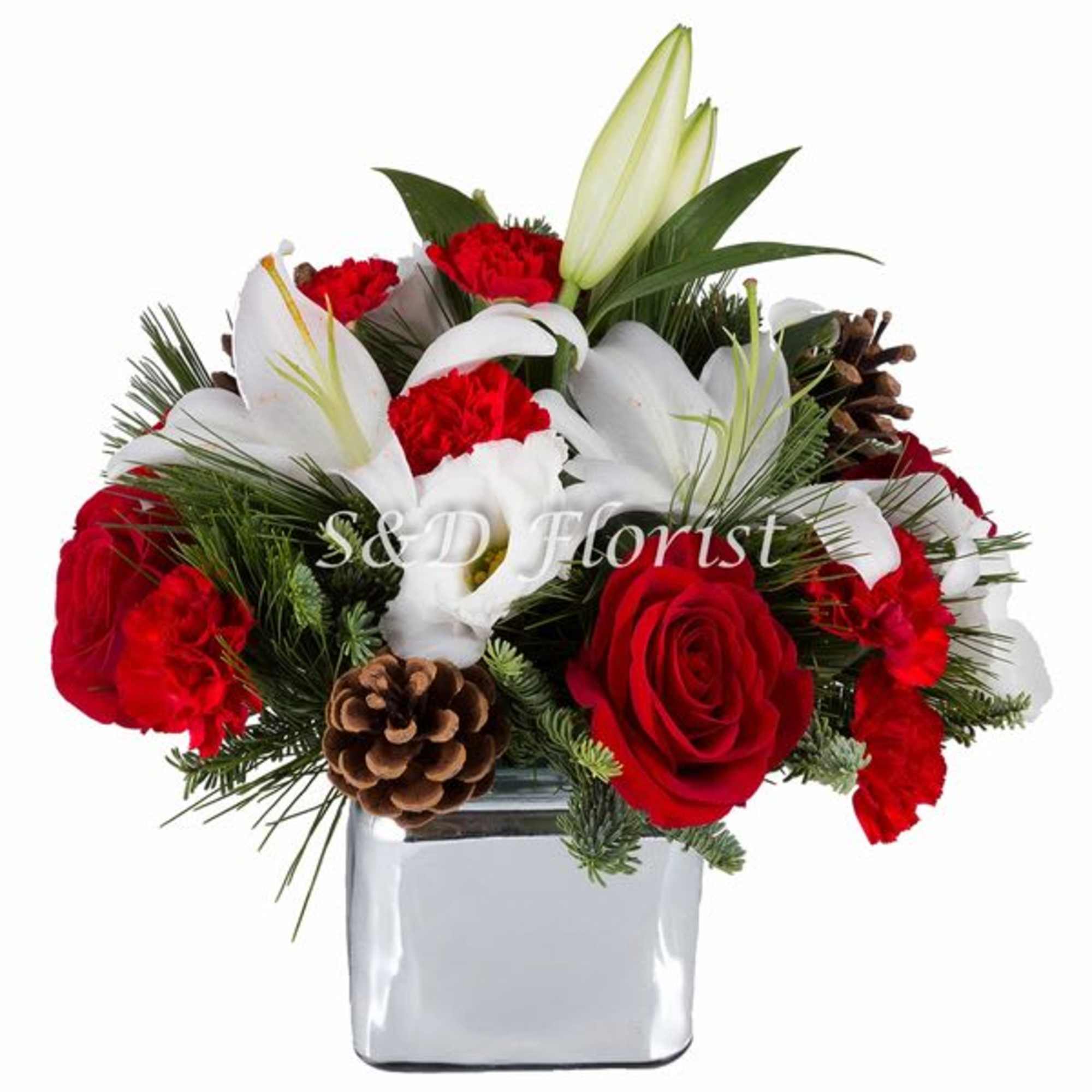 Red roses and white lilies in a square glass vase with pinecones
