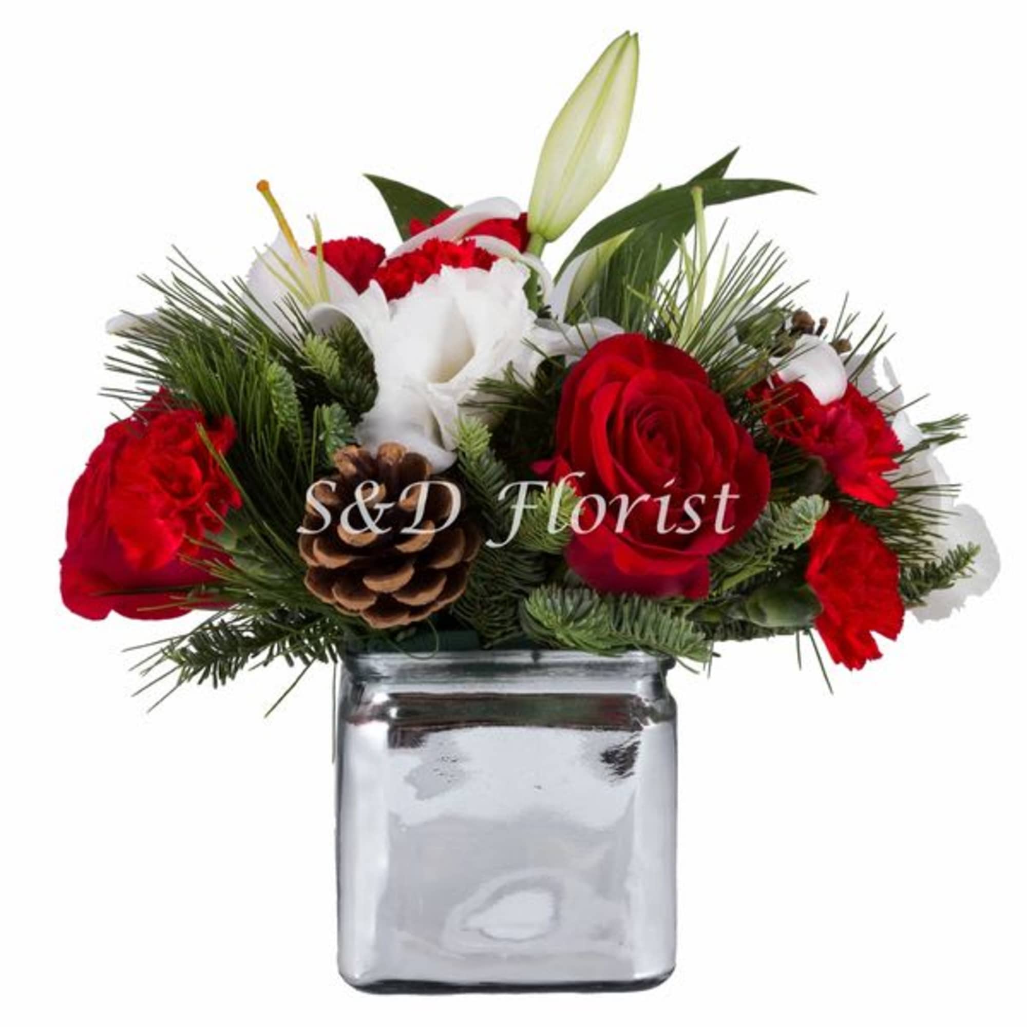Red and white floral arrangement in a clear glass vase with a pinecone